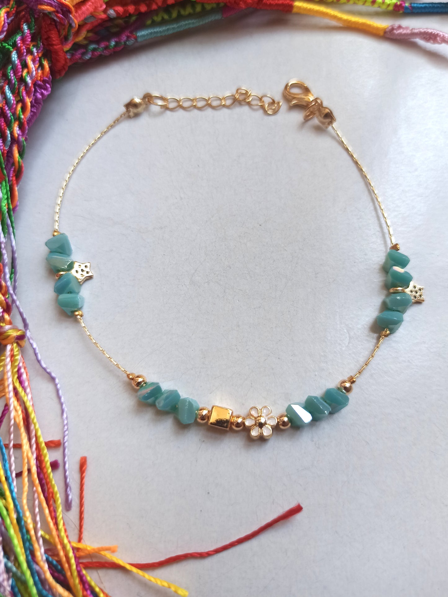 Golden anklet with turquoise flower