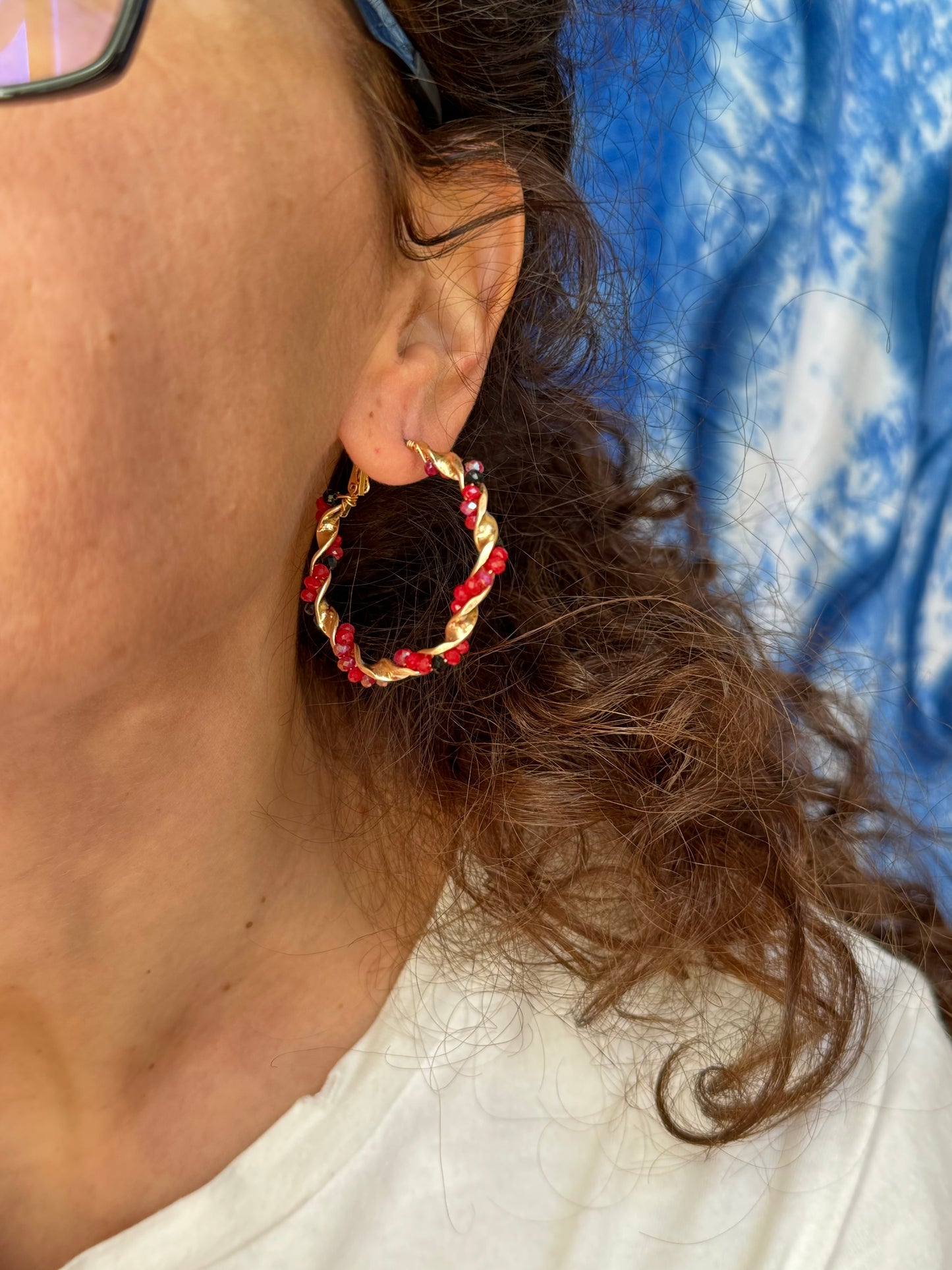 Golden earrings with red beaded circles