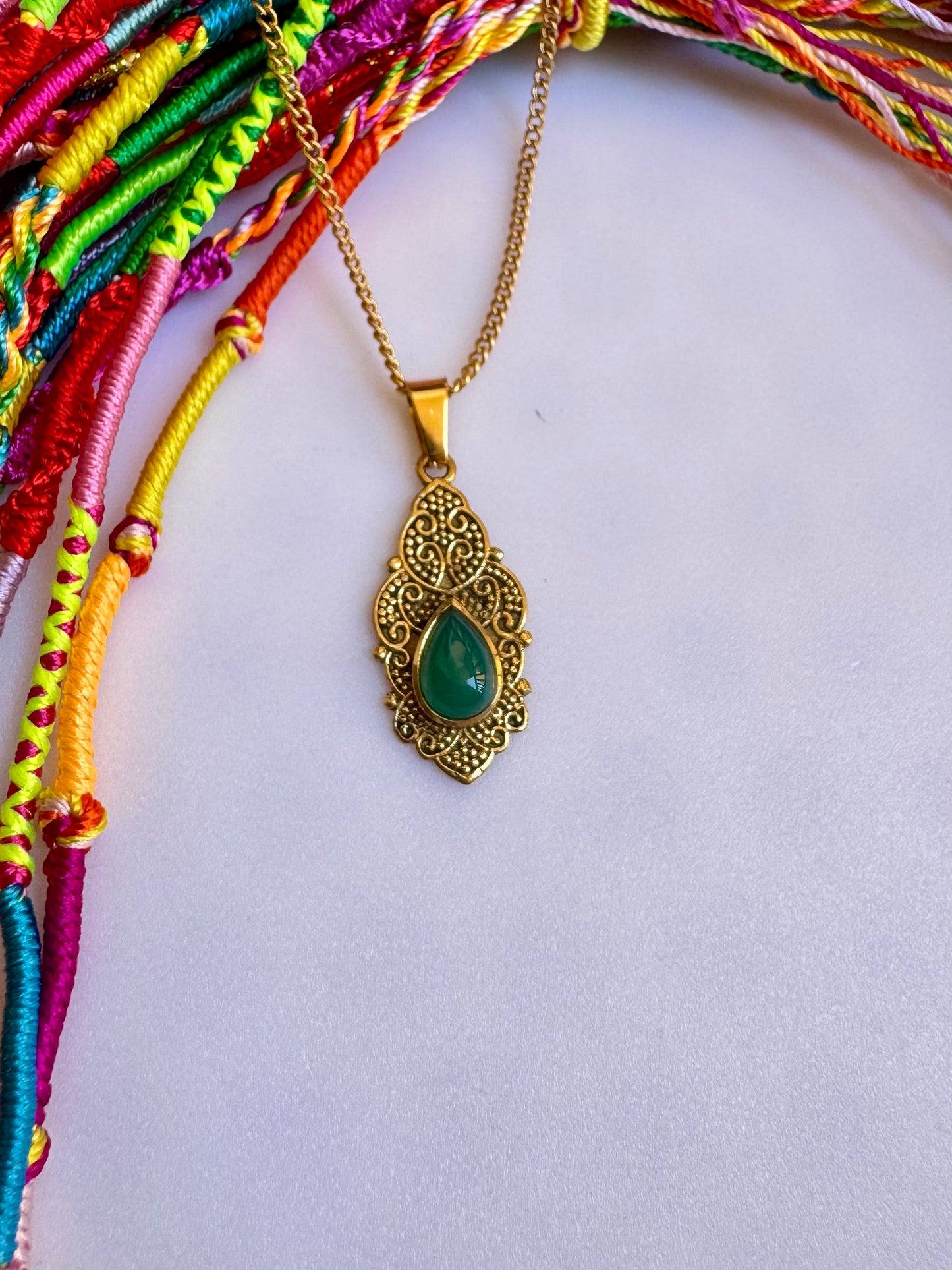 Golden necklace with green pendant