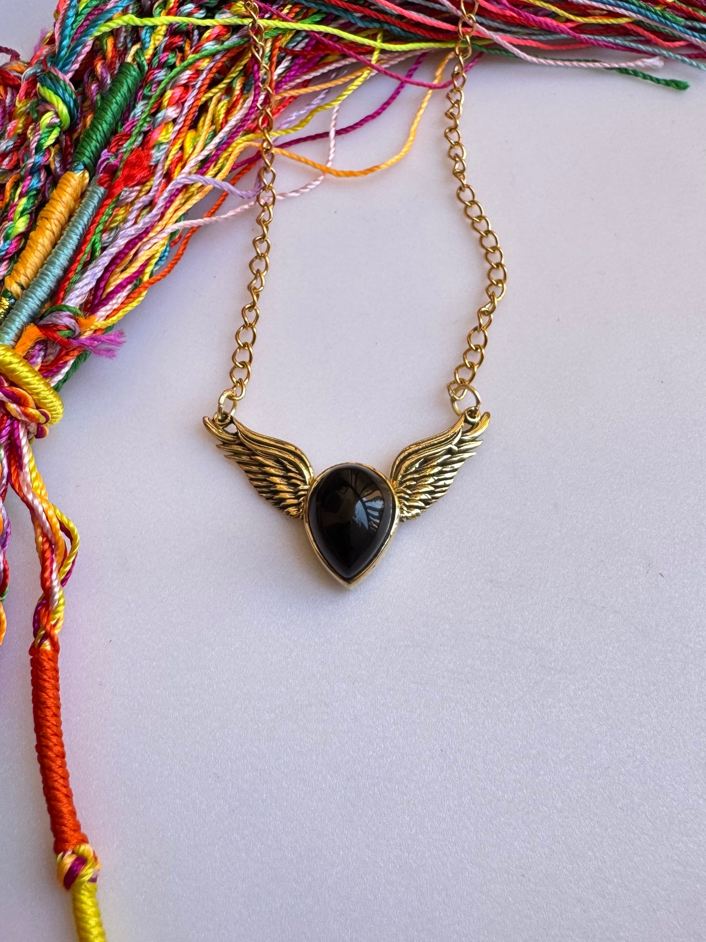 Golden necklace with black pendant