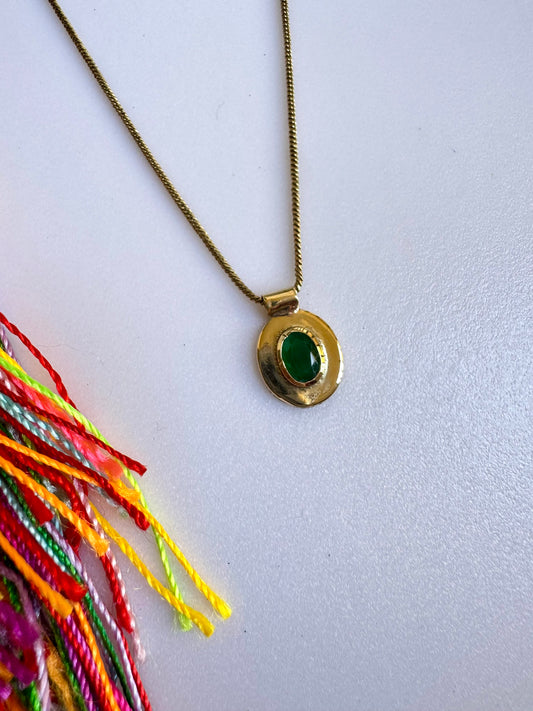 Golden necklace with green pendant