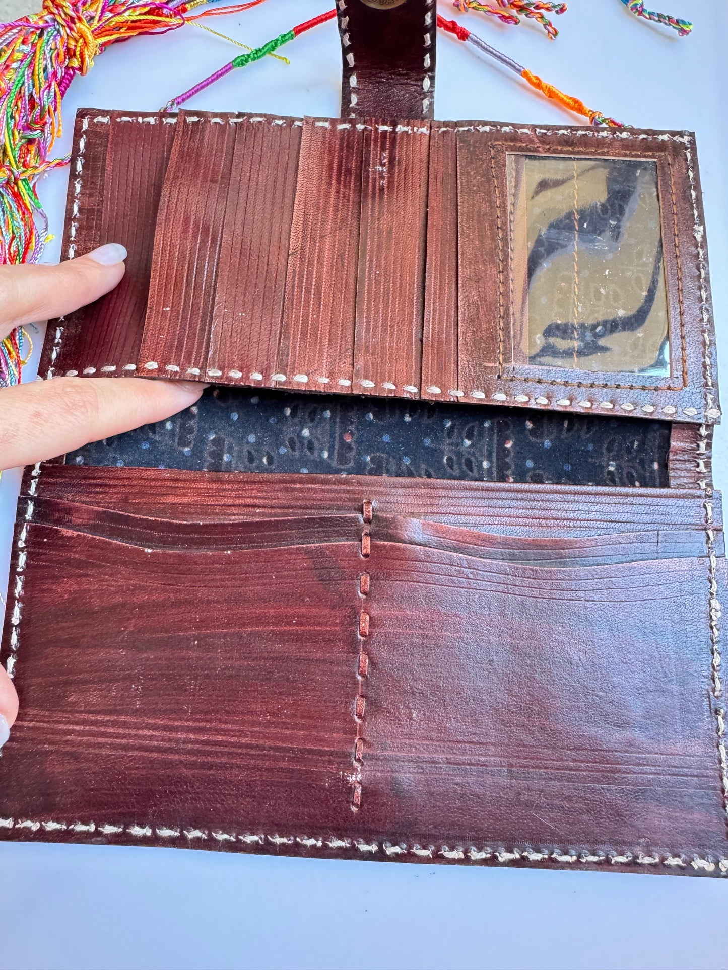 Brown leather wallet with colorful floral engravings