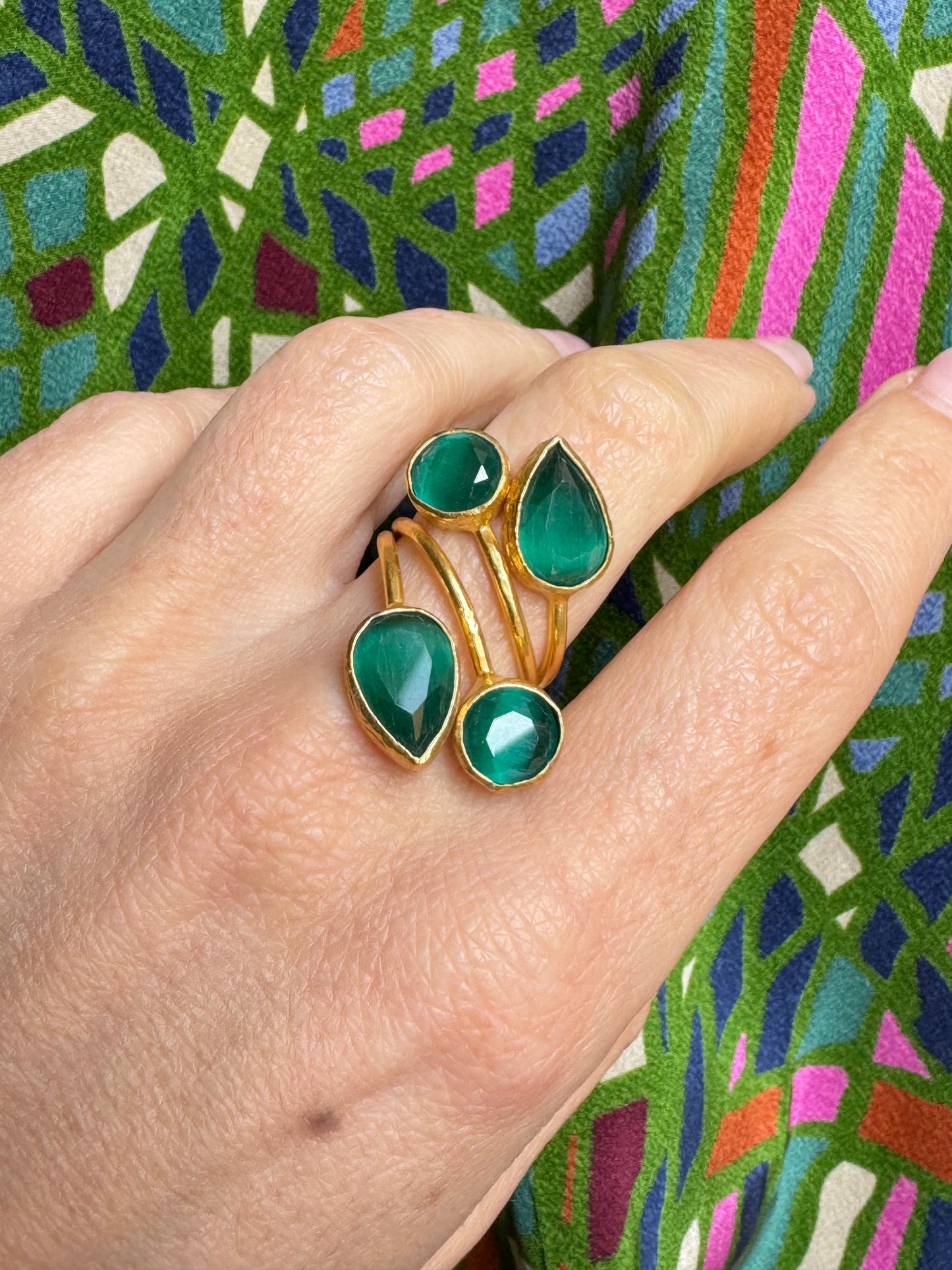 Golden ring with 4 green stones