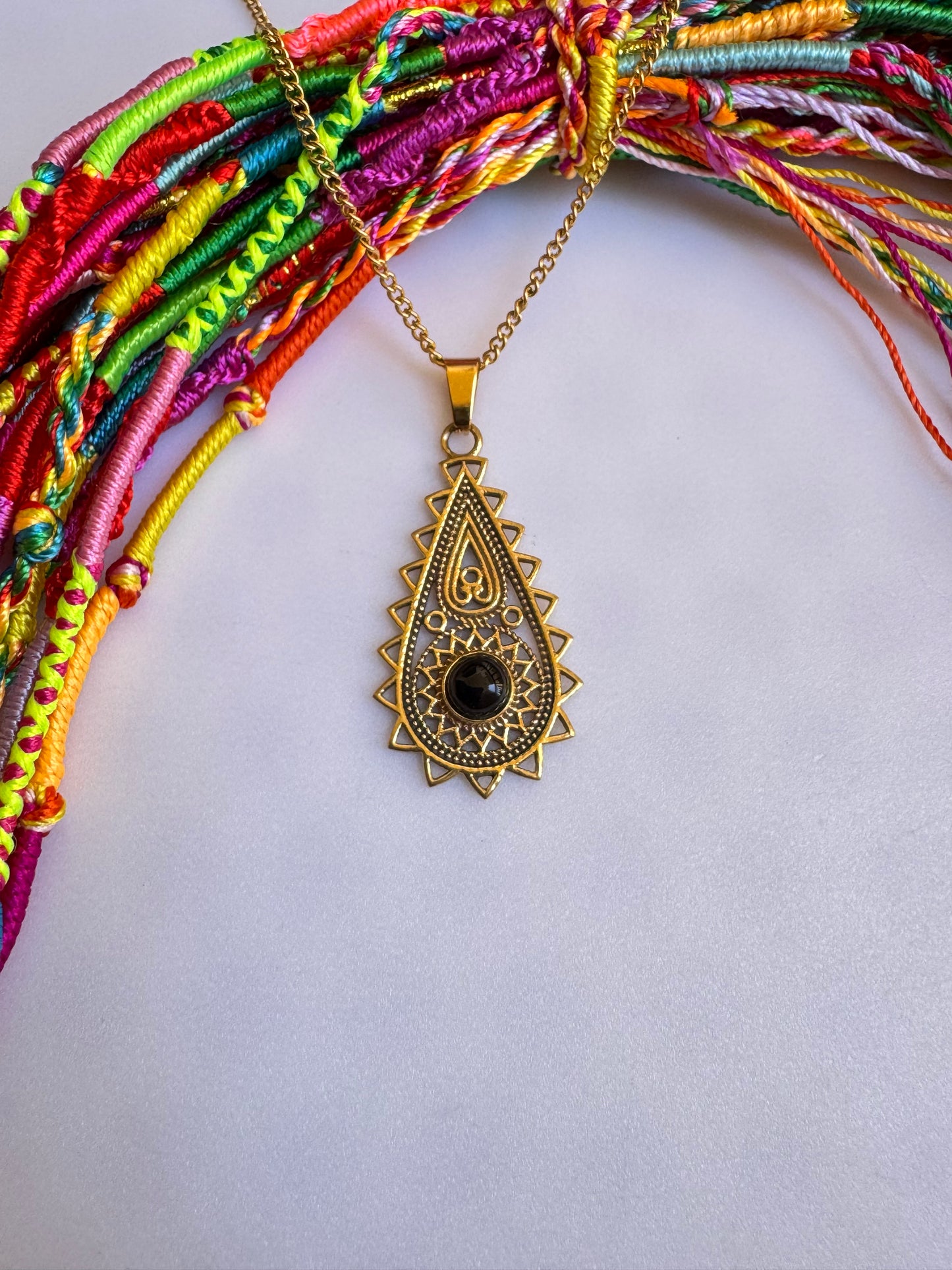 Golden necklace with black pendant
