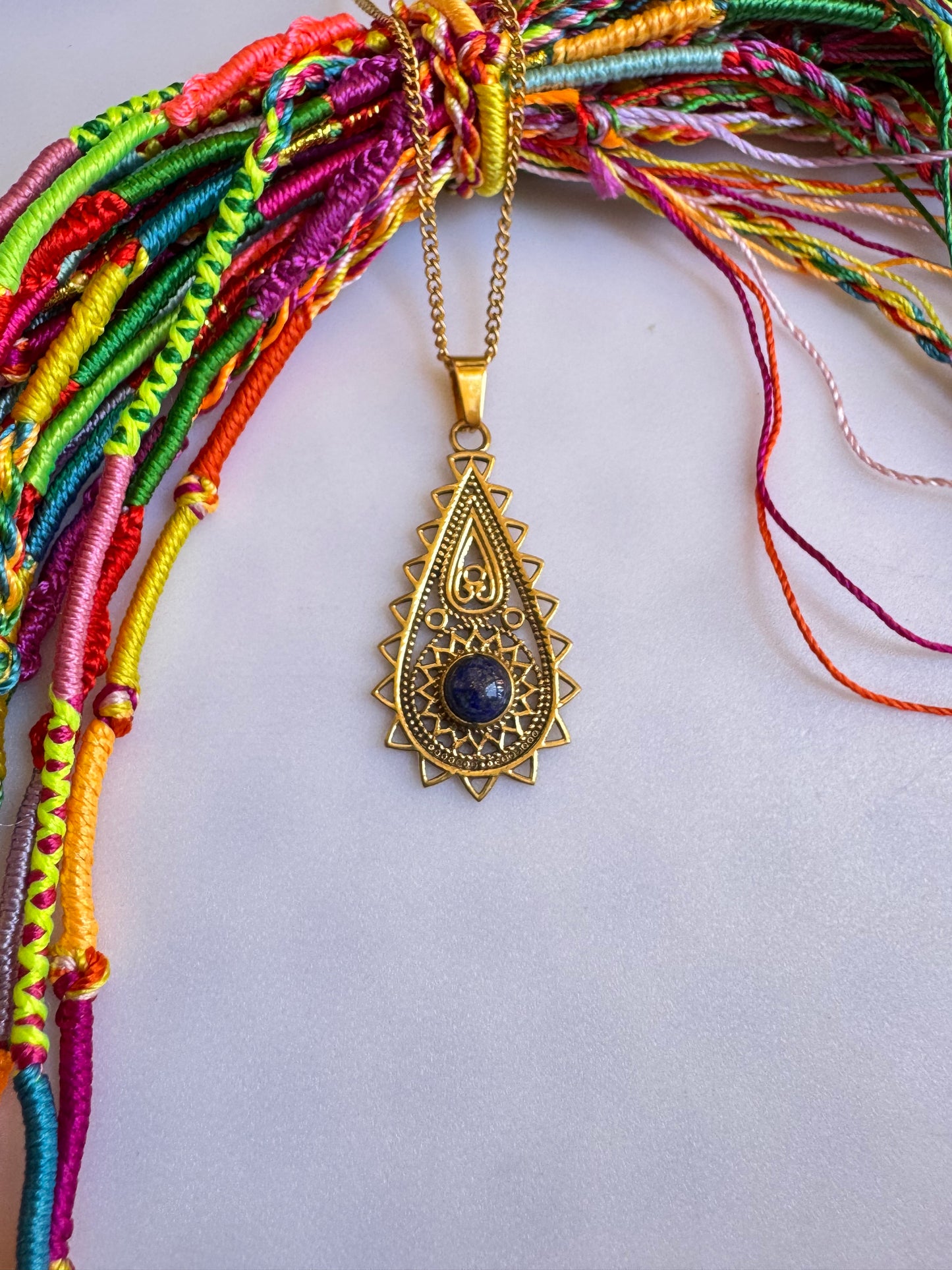 Golden necklace with blue pendant