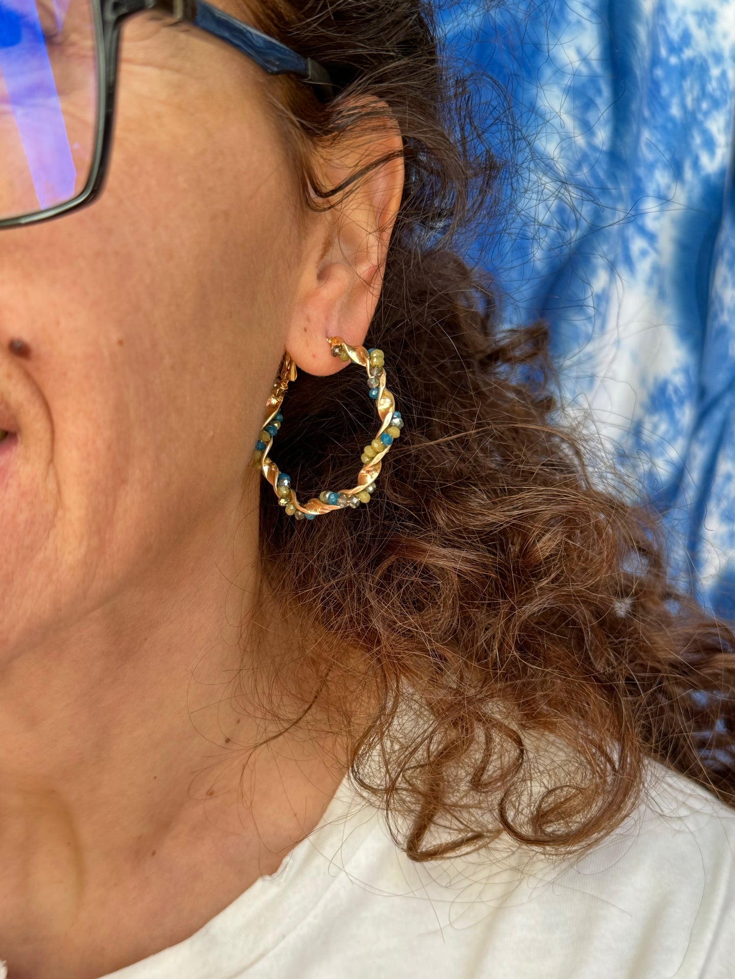 Golden earrings with green beaded circles