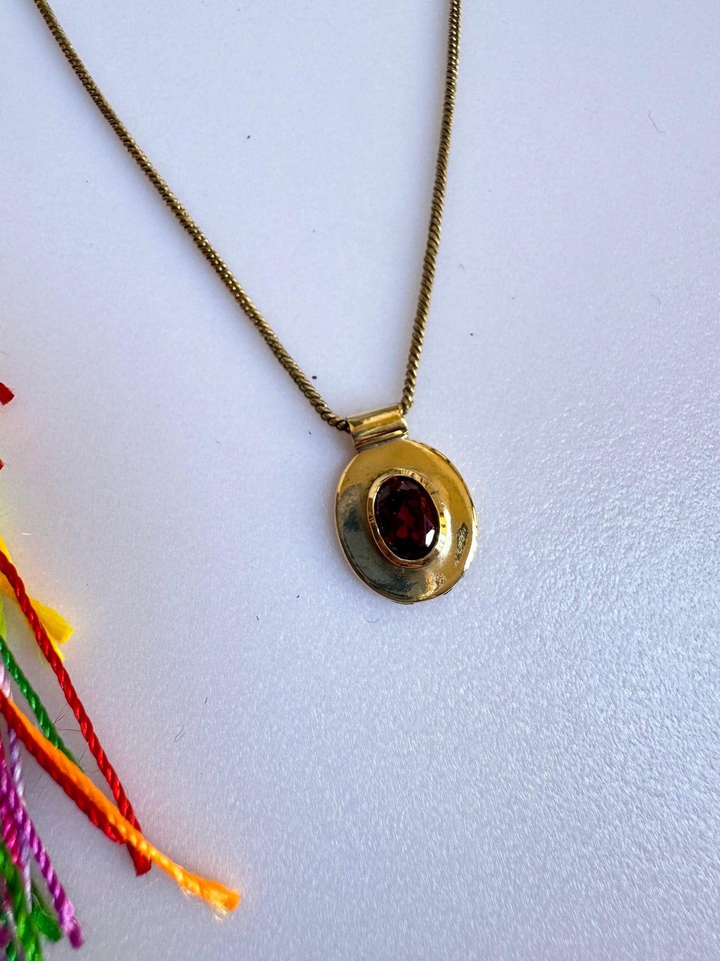 Collana dorata con ciondolo rosso