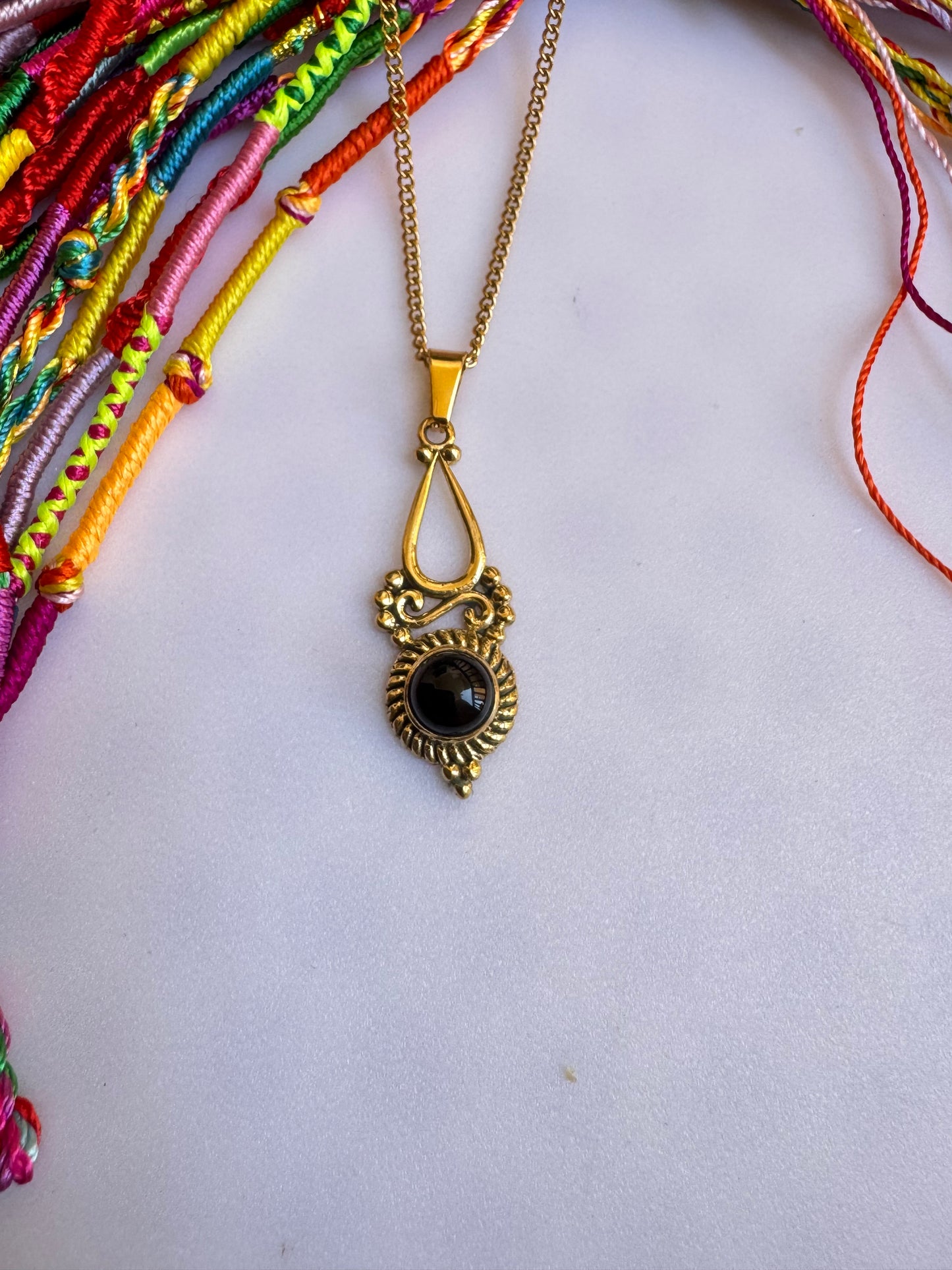 Golden necklace with black pendant