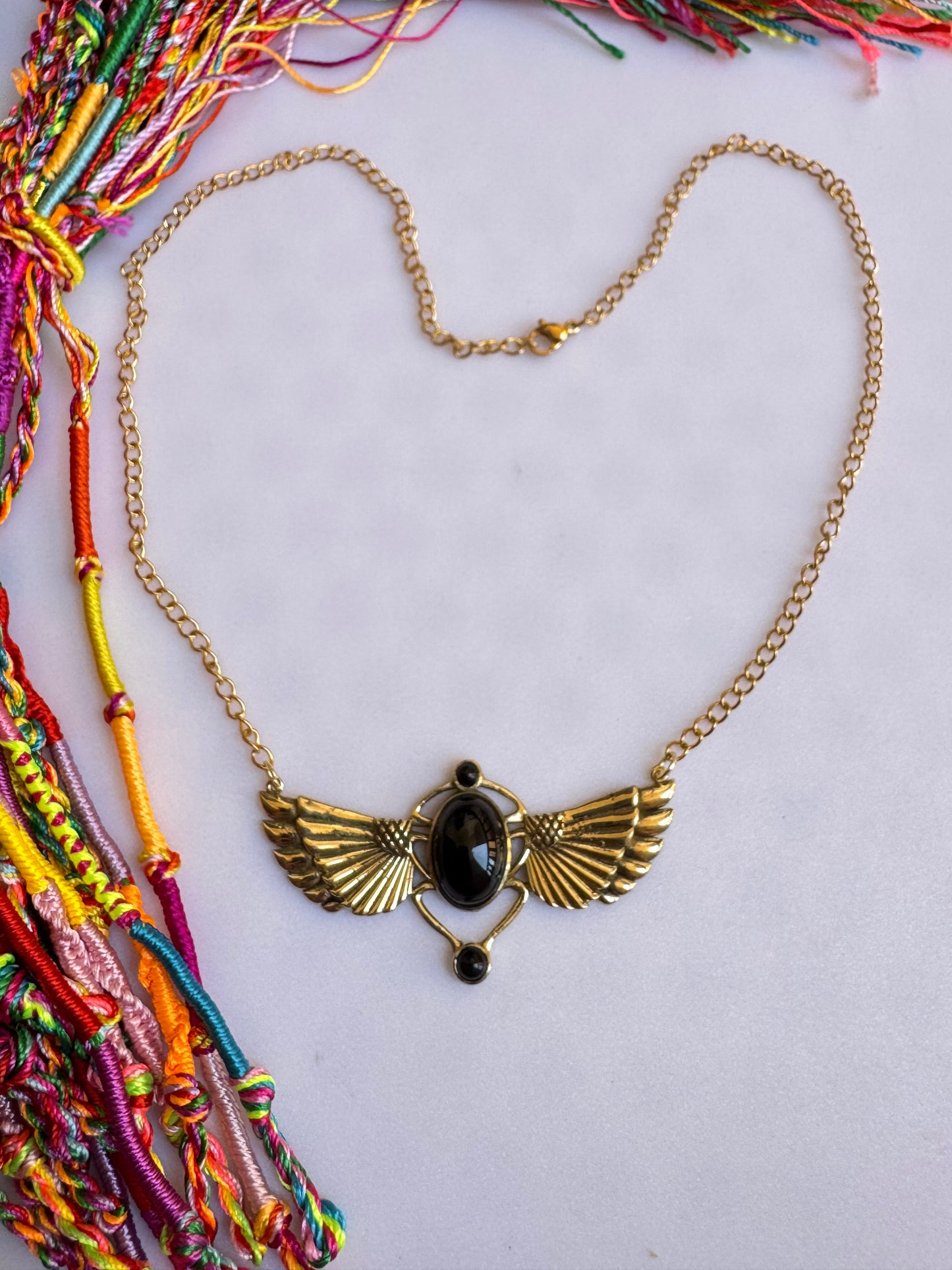 Golden necklace with black pendant