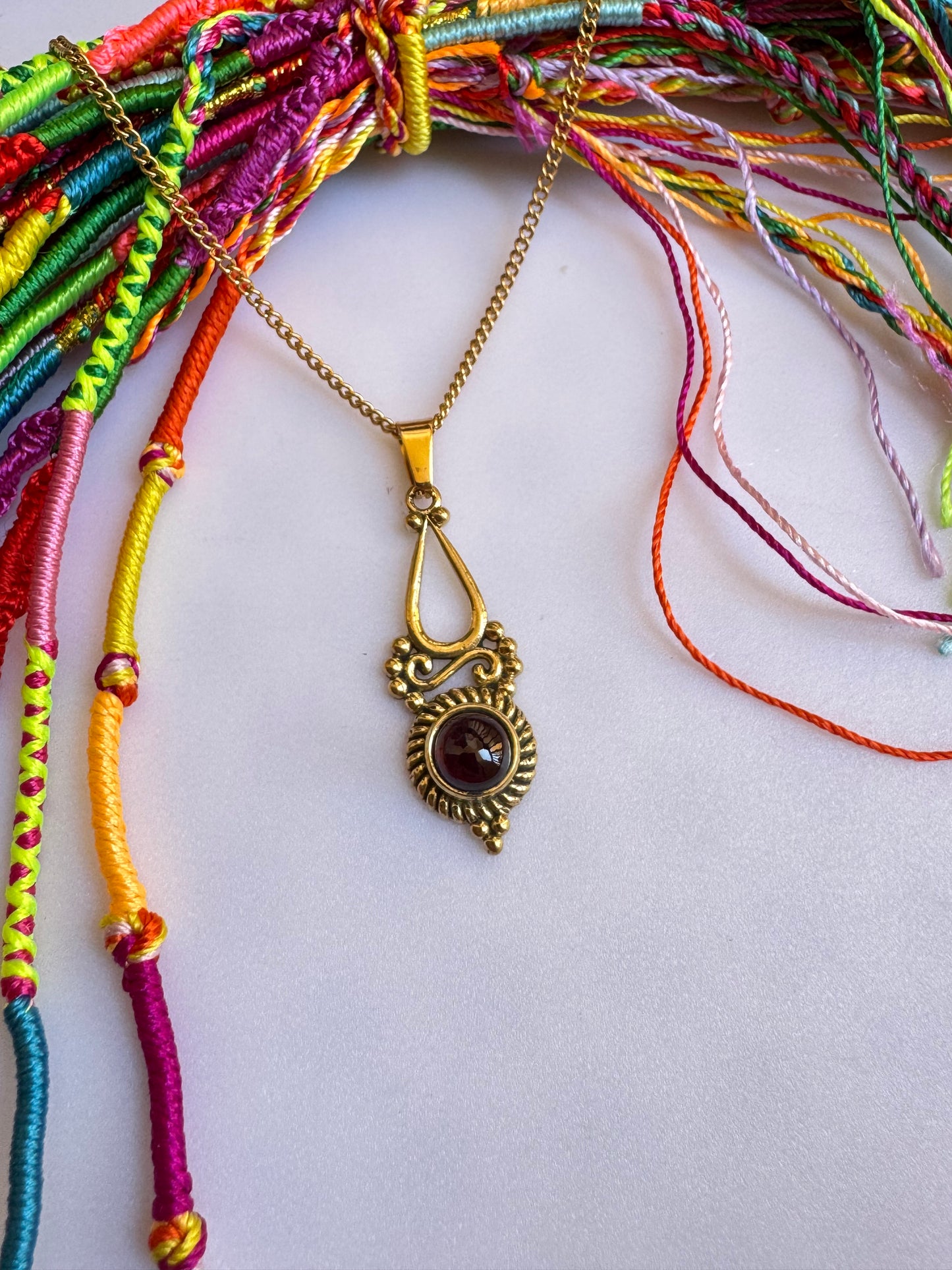 Golden necklace with red pendant