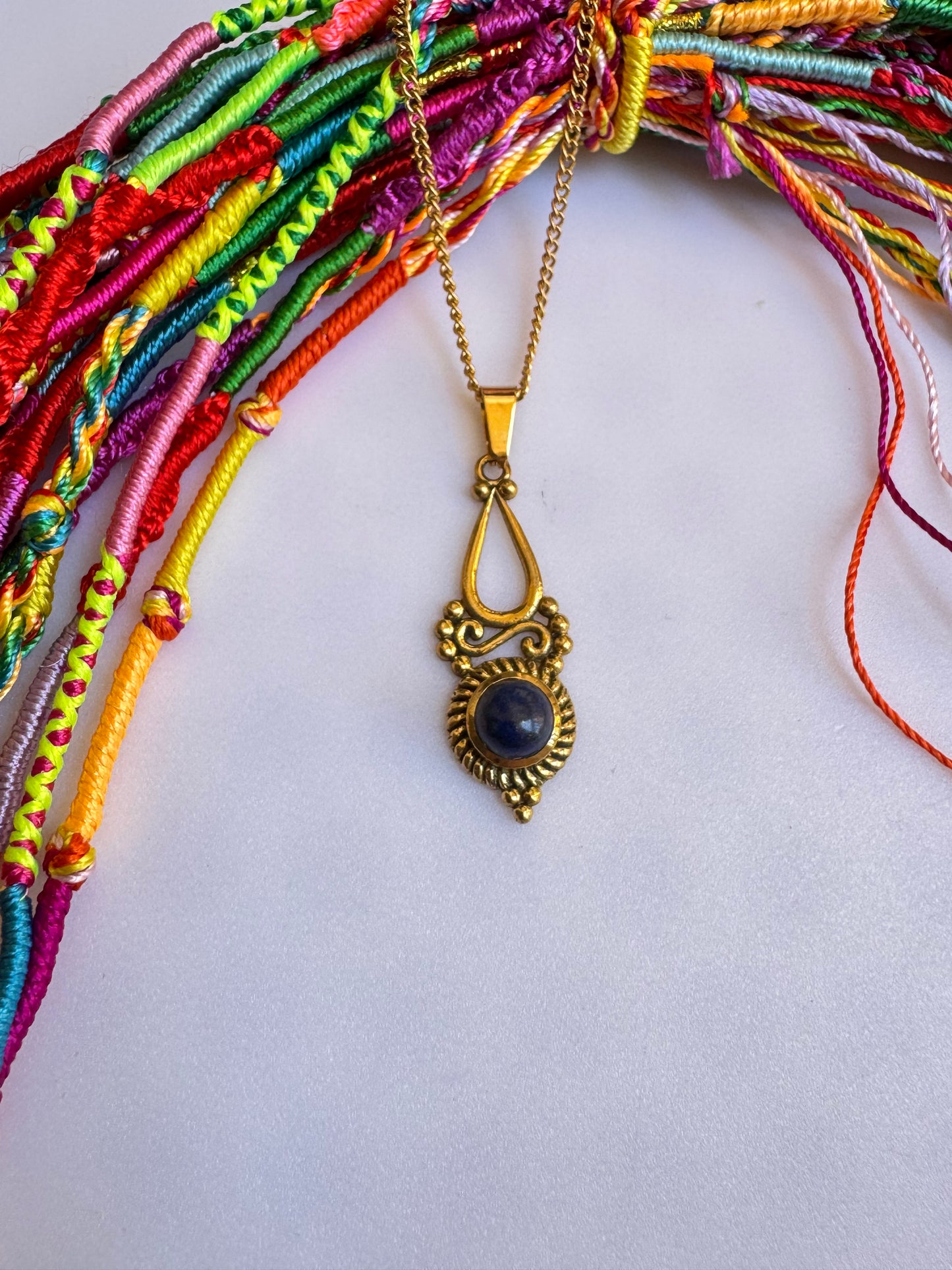 Golden necklace with blue pendant