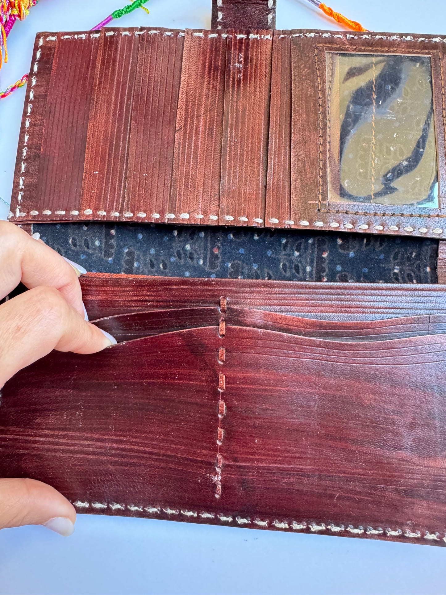 Brown leather wallet with colorful floral engravings