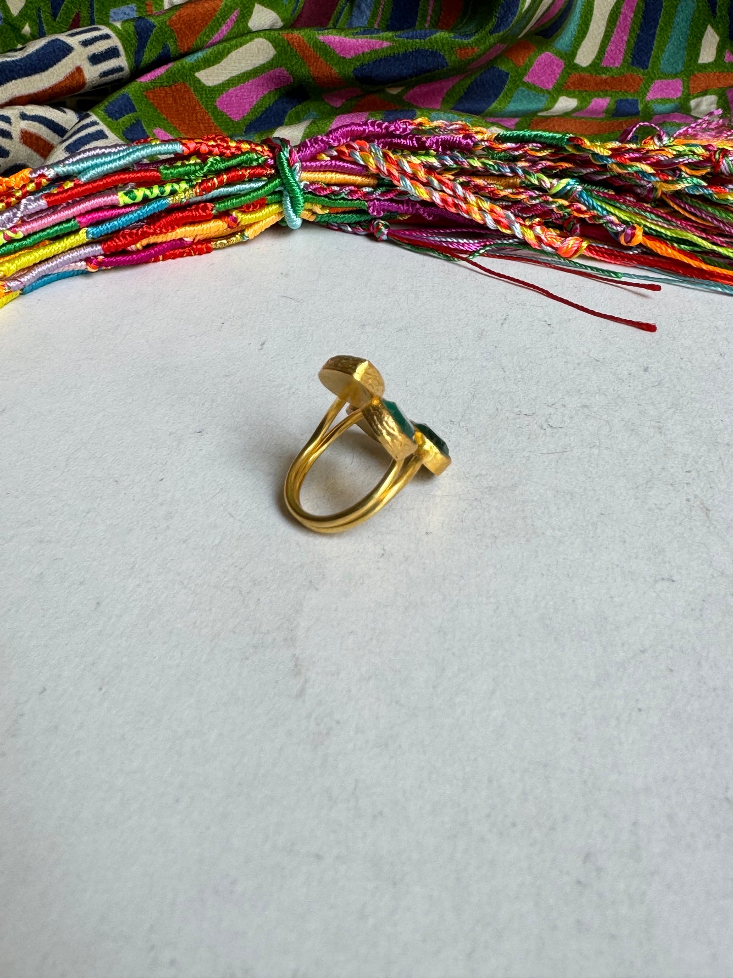 Golden ring with 4 green stones