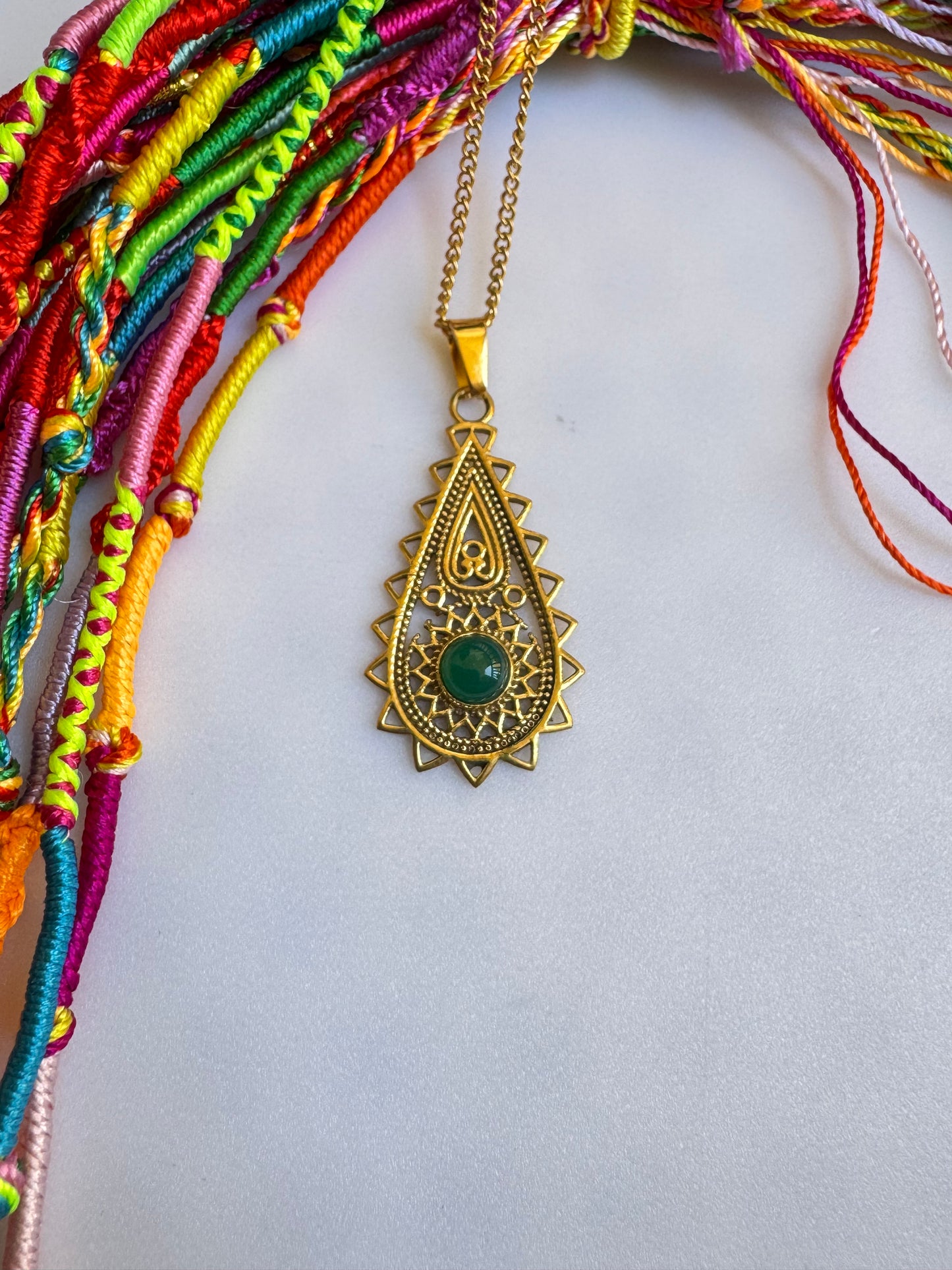 Golden necklace with green pendant