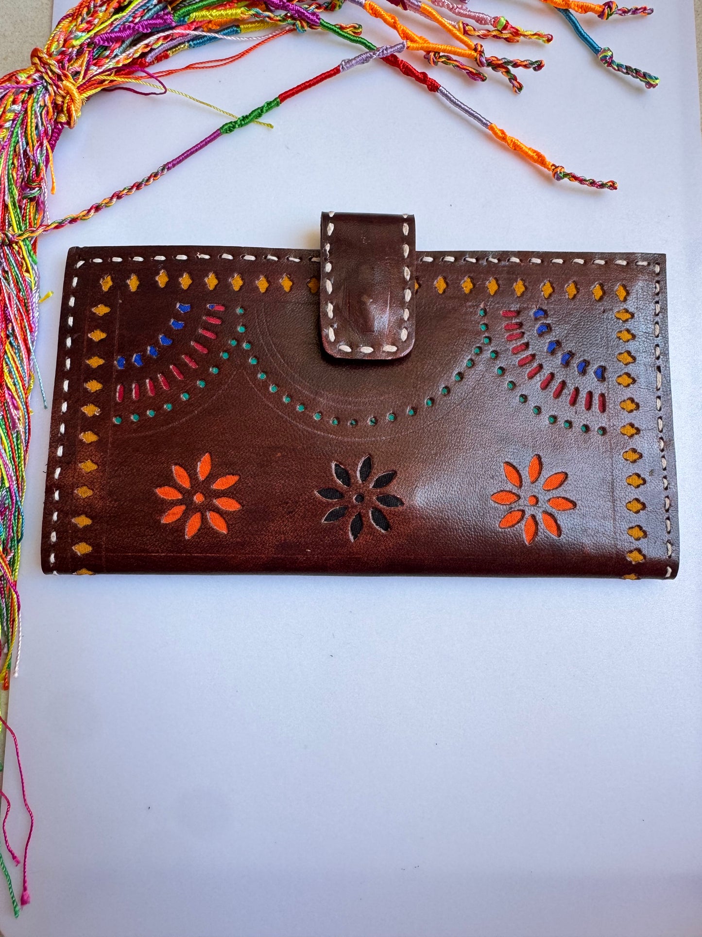 Brown leather wallet with colorful floral engravings