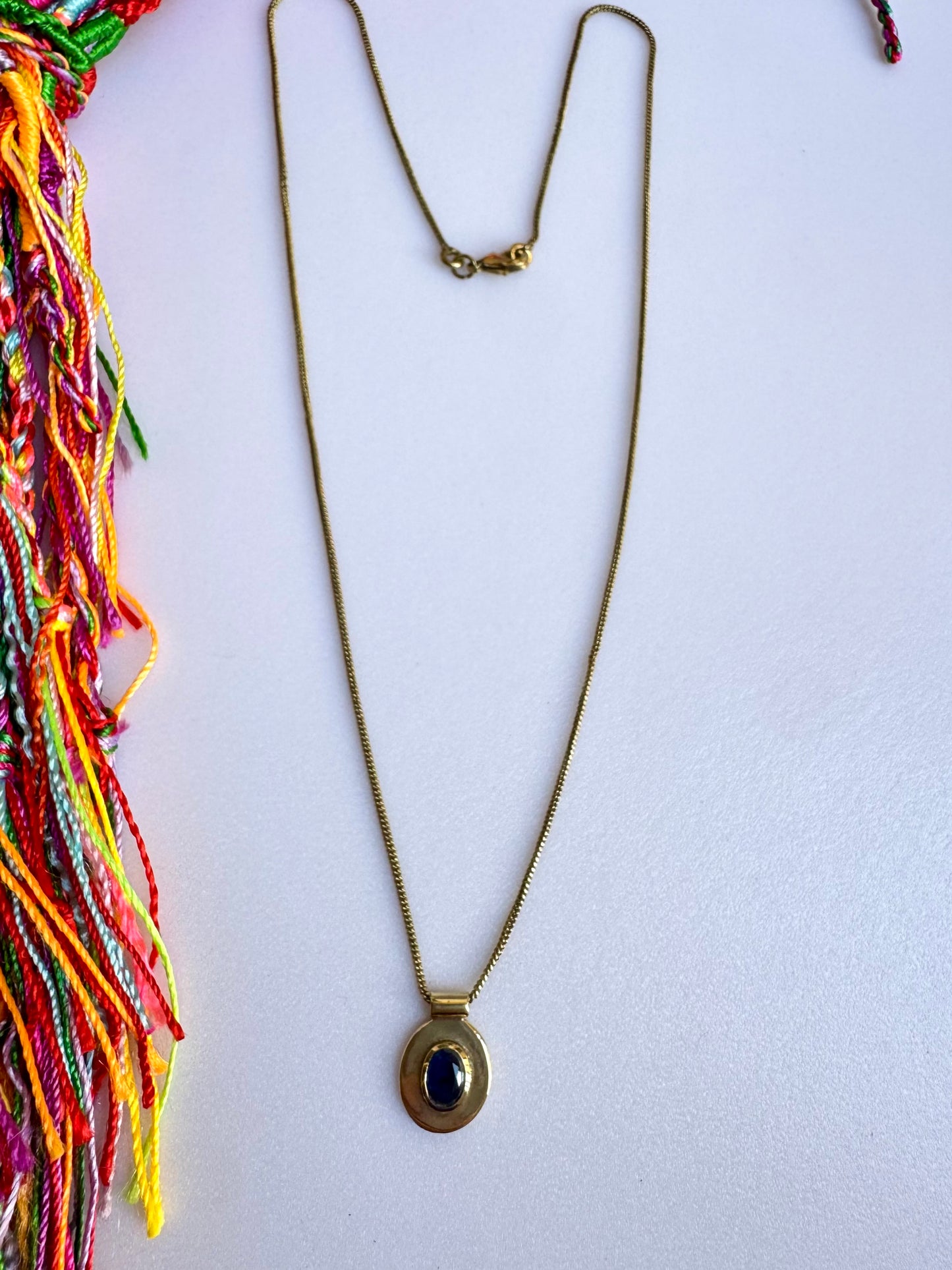 Collana dorata con ciondolo blu