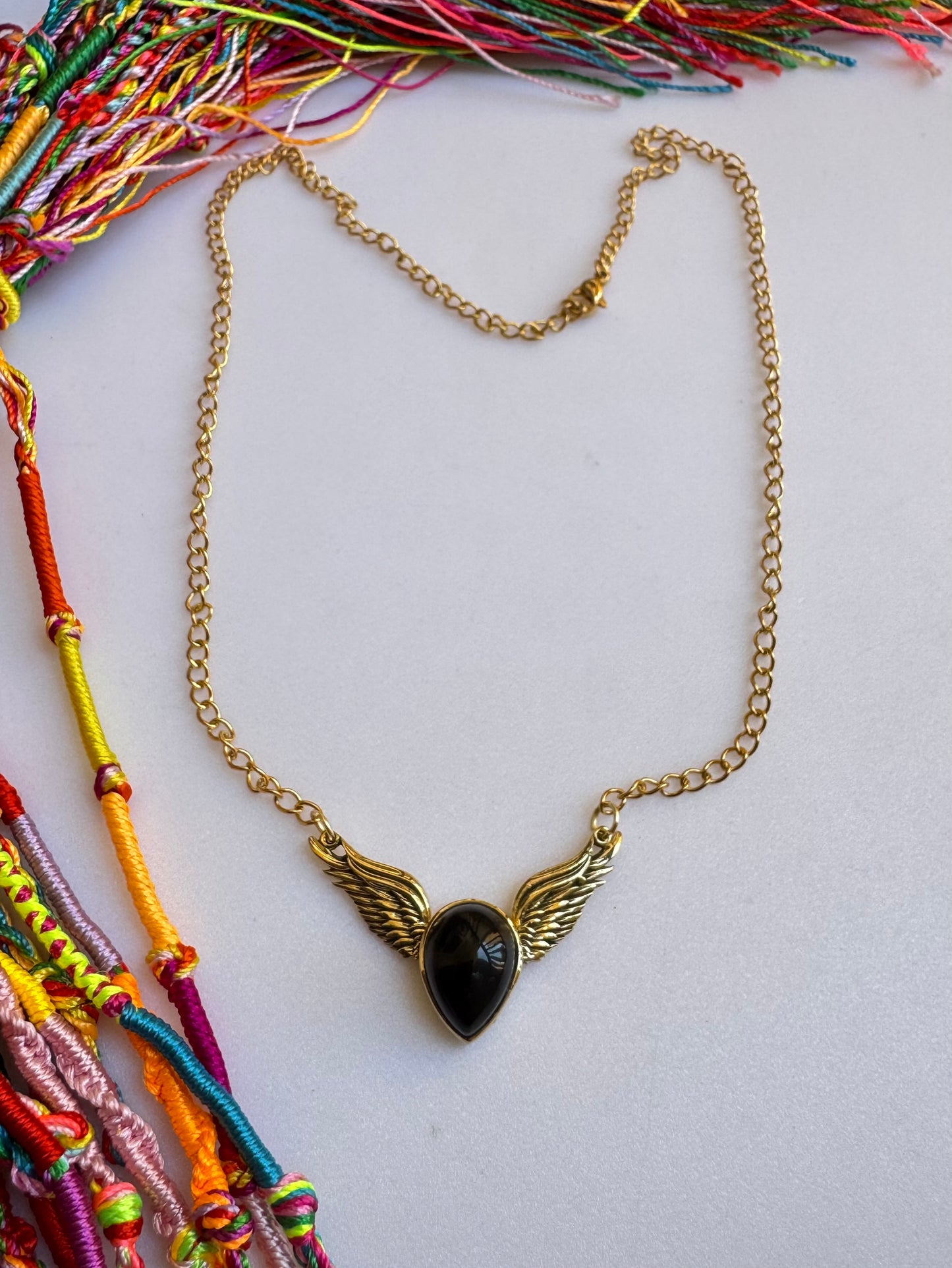 Golden necklace with black pendant