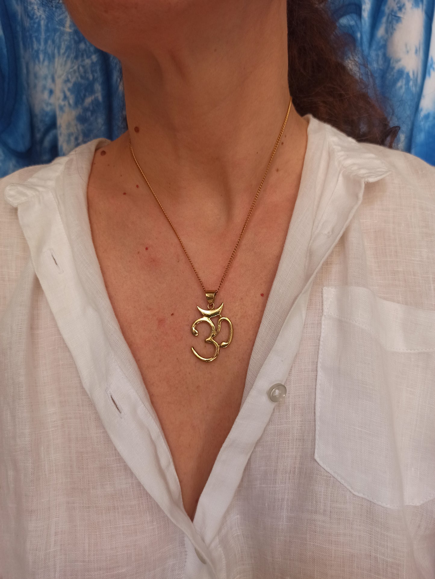 Golden necklace with ohm pendant