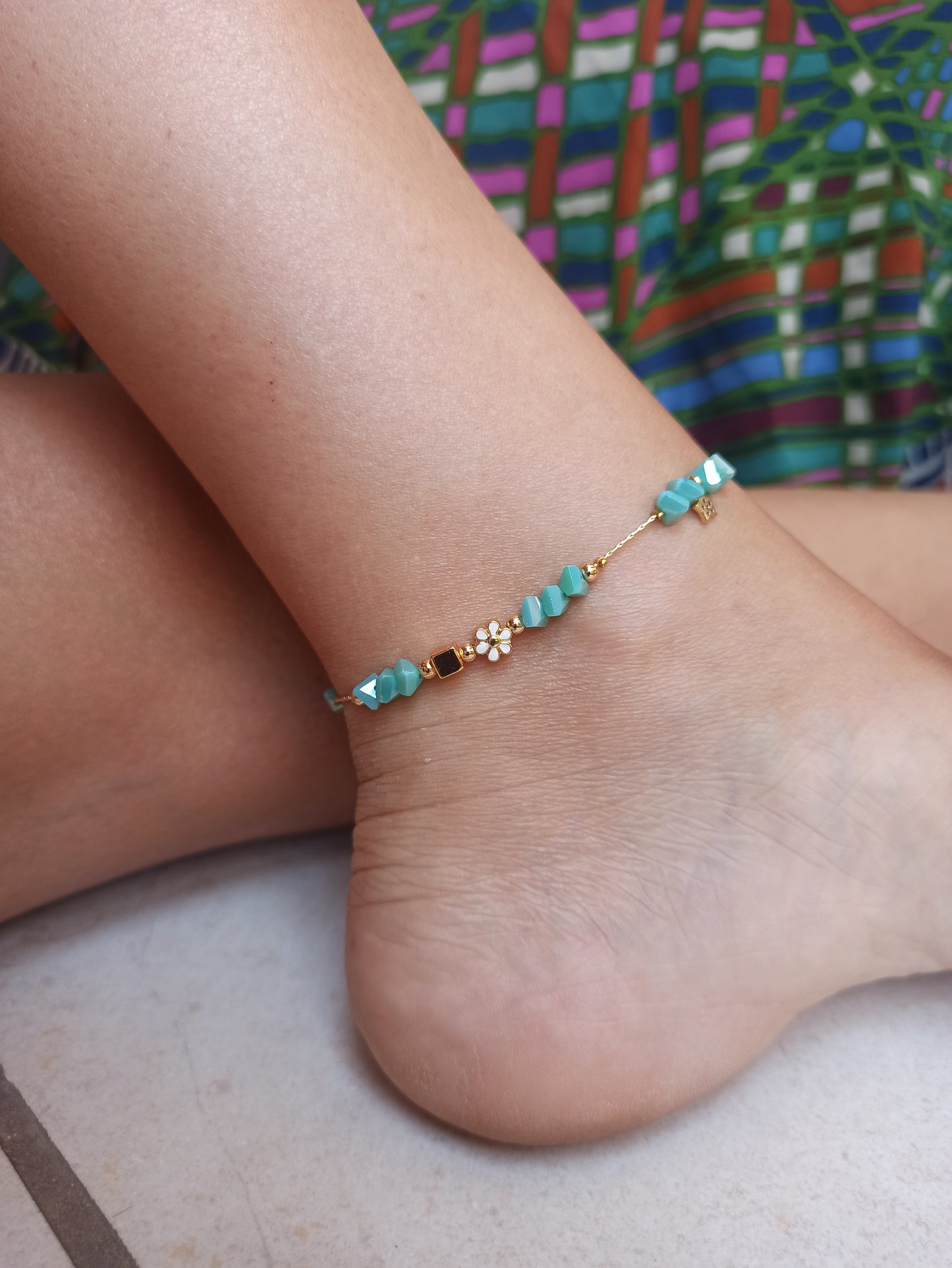 Golden anklet with turquoise flower