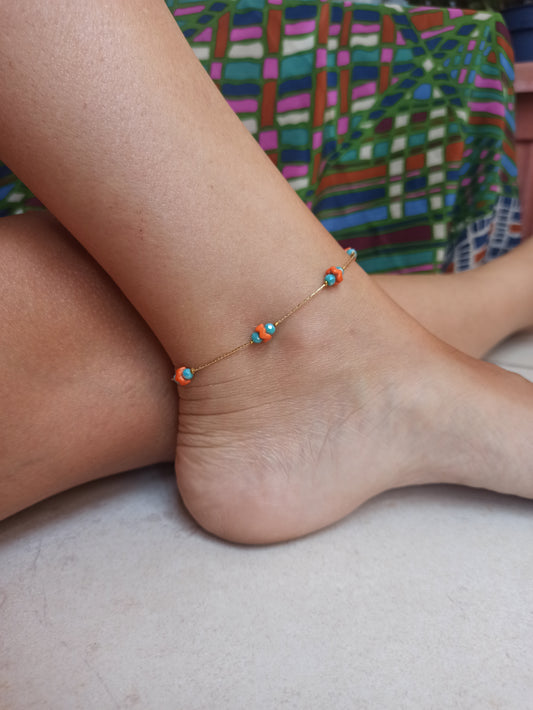 Golden anklet with turquoise and orange decoration