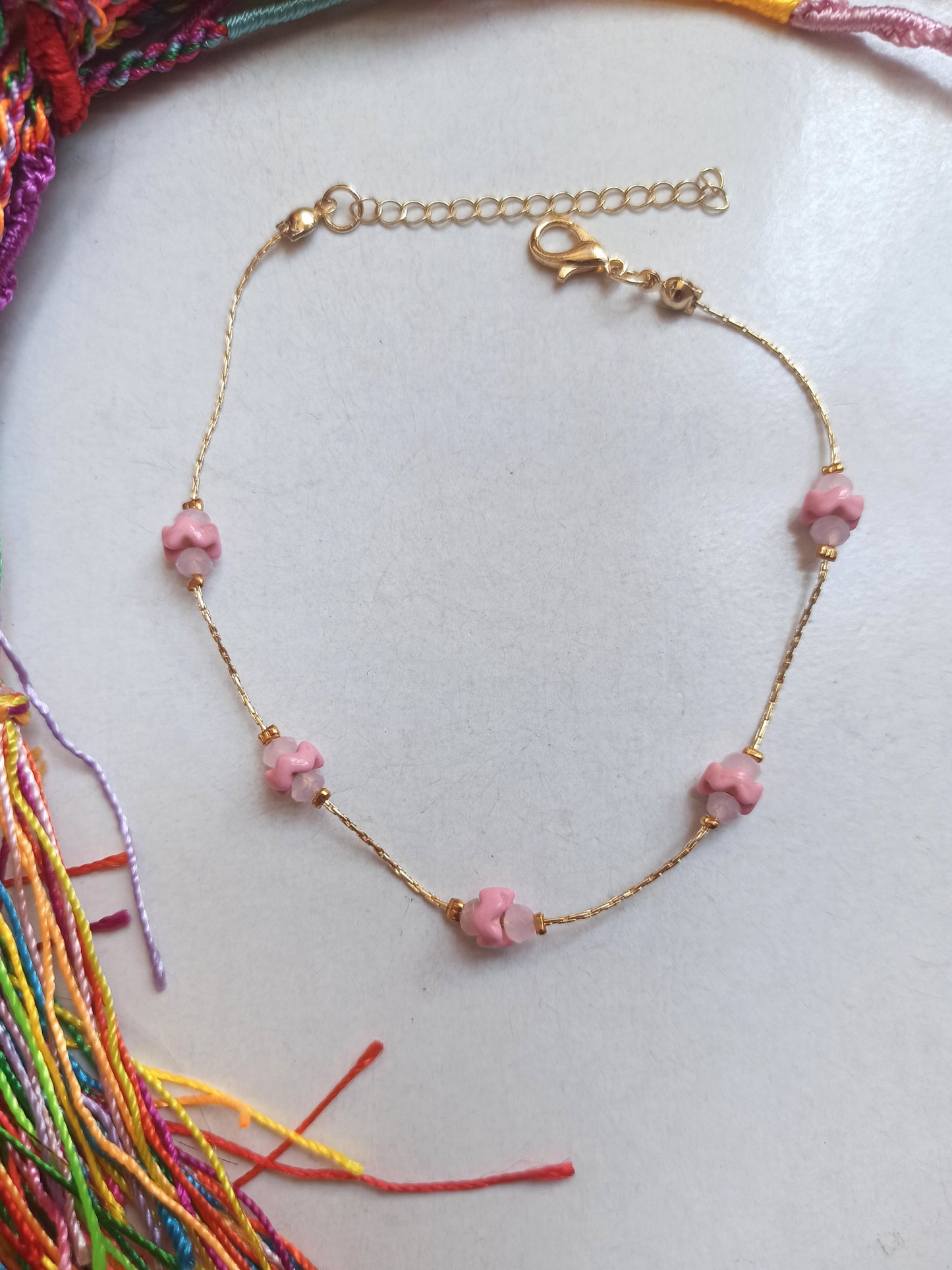 Golden anklet with pink decoration