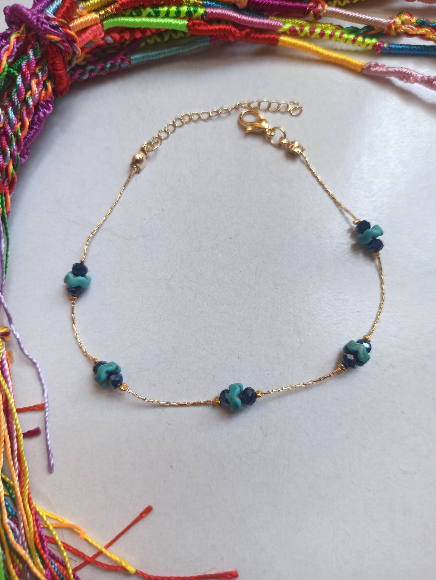 Golden anklet with turquoise and blue decoration