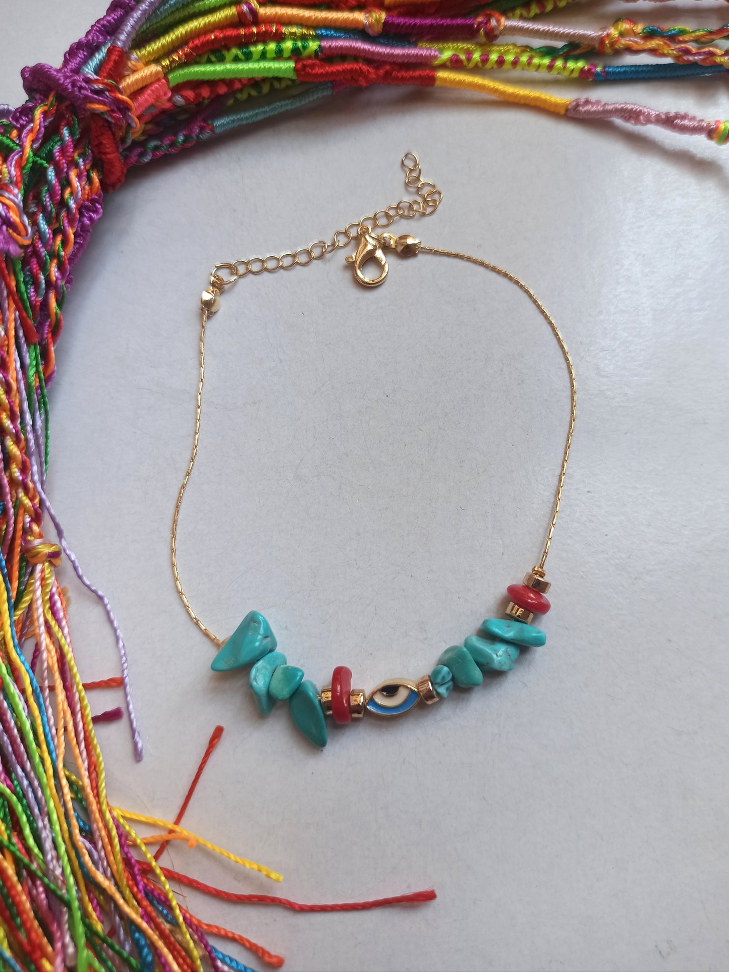 Golden anklet with turquoise eye