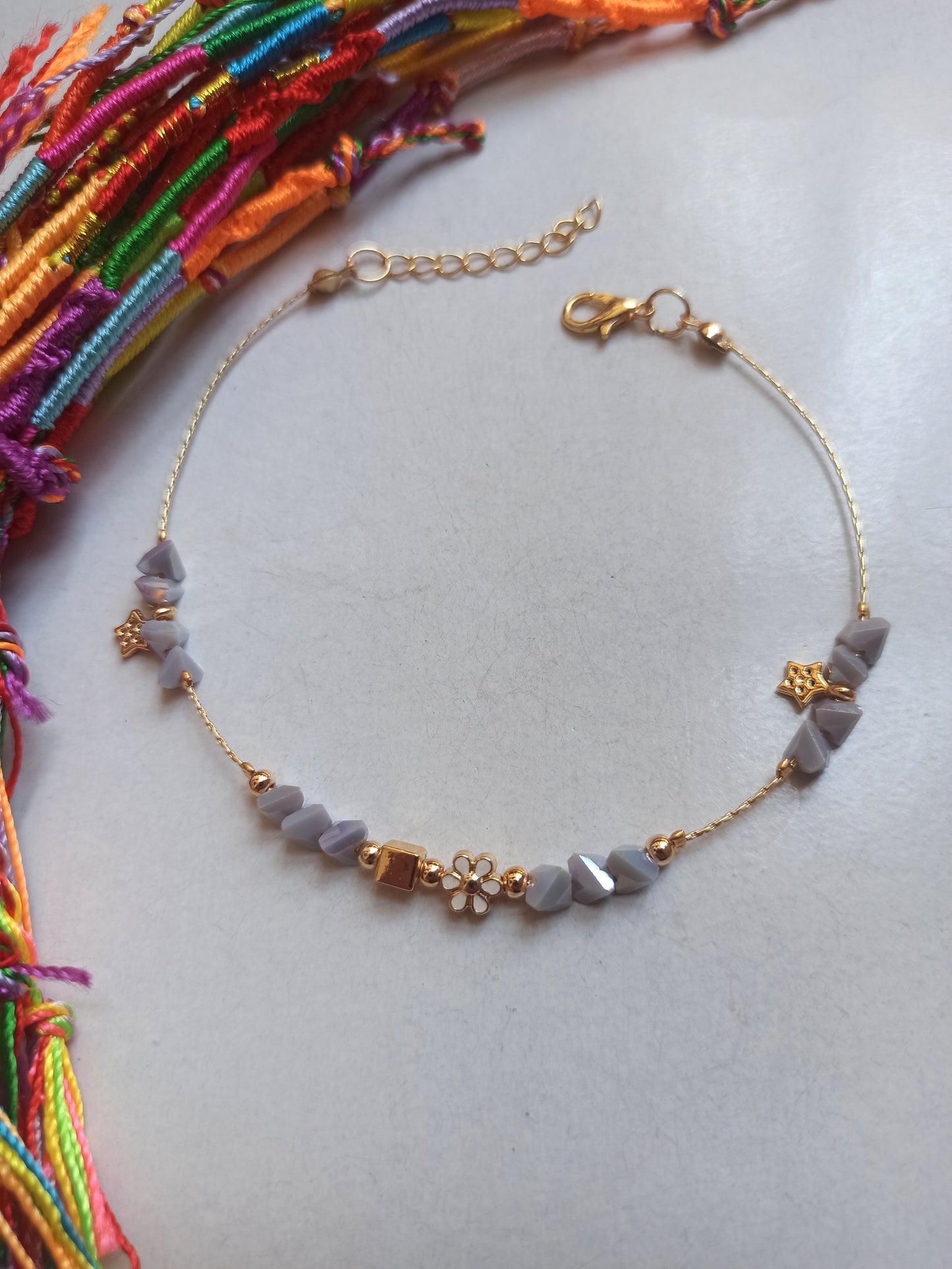 Golden anklet with lilac flower