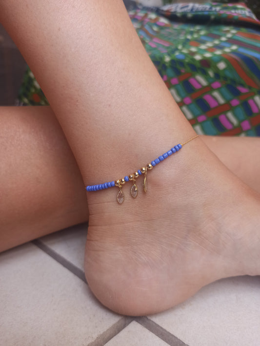 Golden anklet with 3 light blue beads