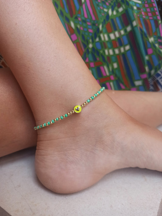 Golden anklet with green beaded heart