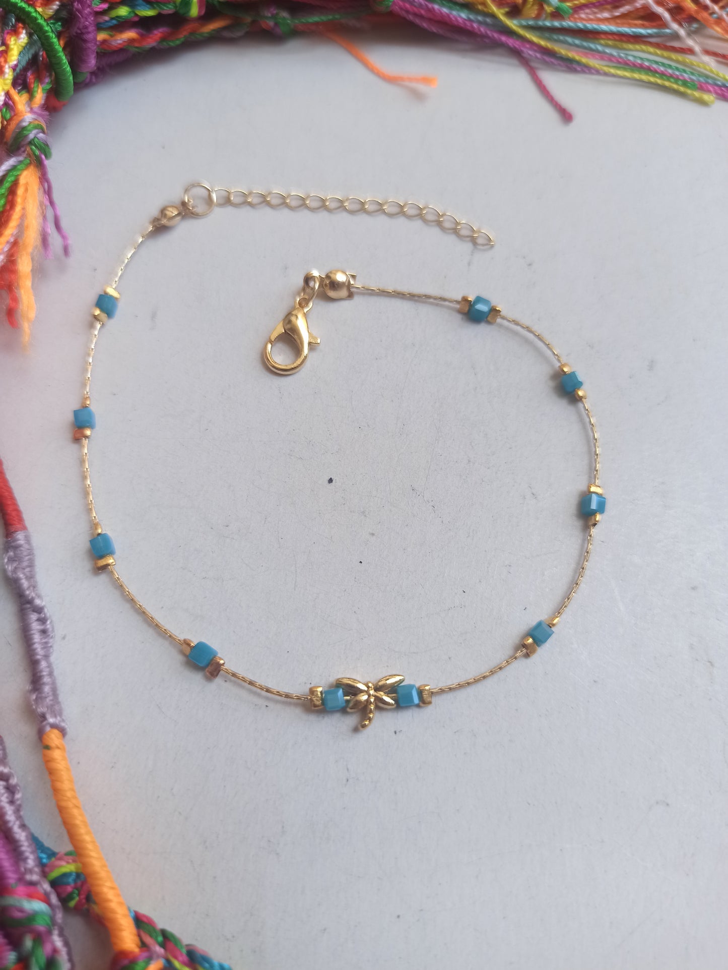 Golden dragonfly anklet with light blue beads