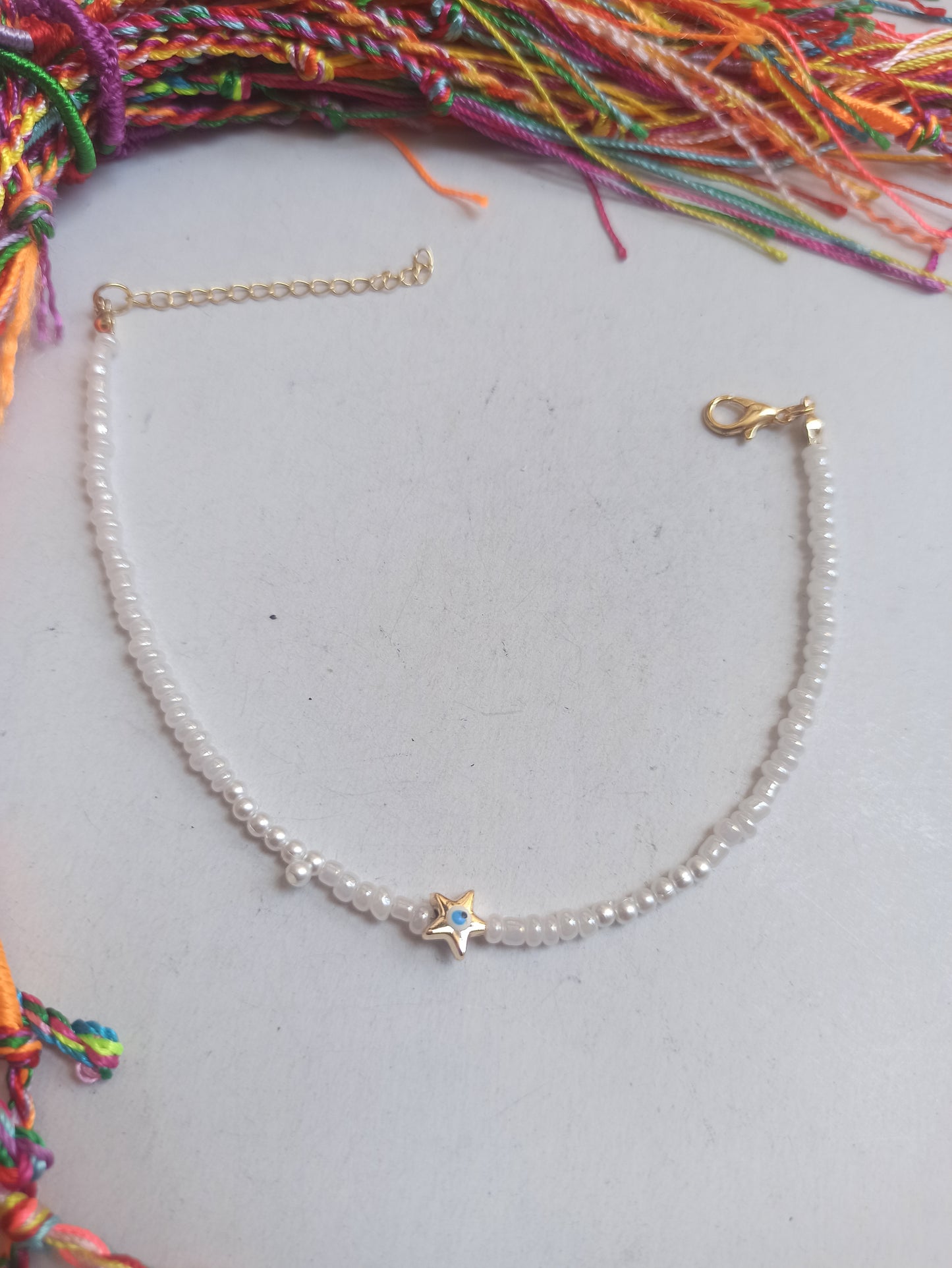 Golden star anklet with white beads