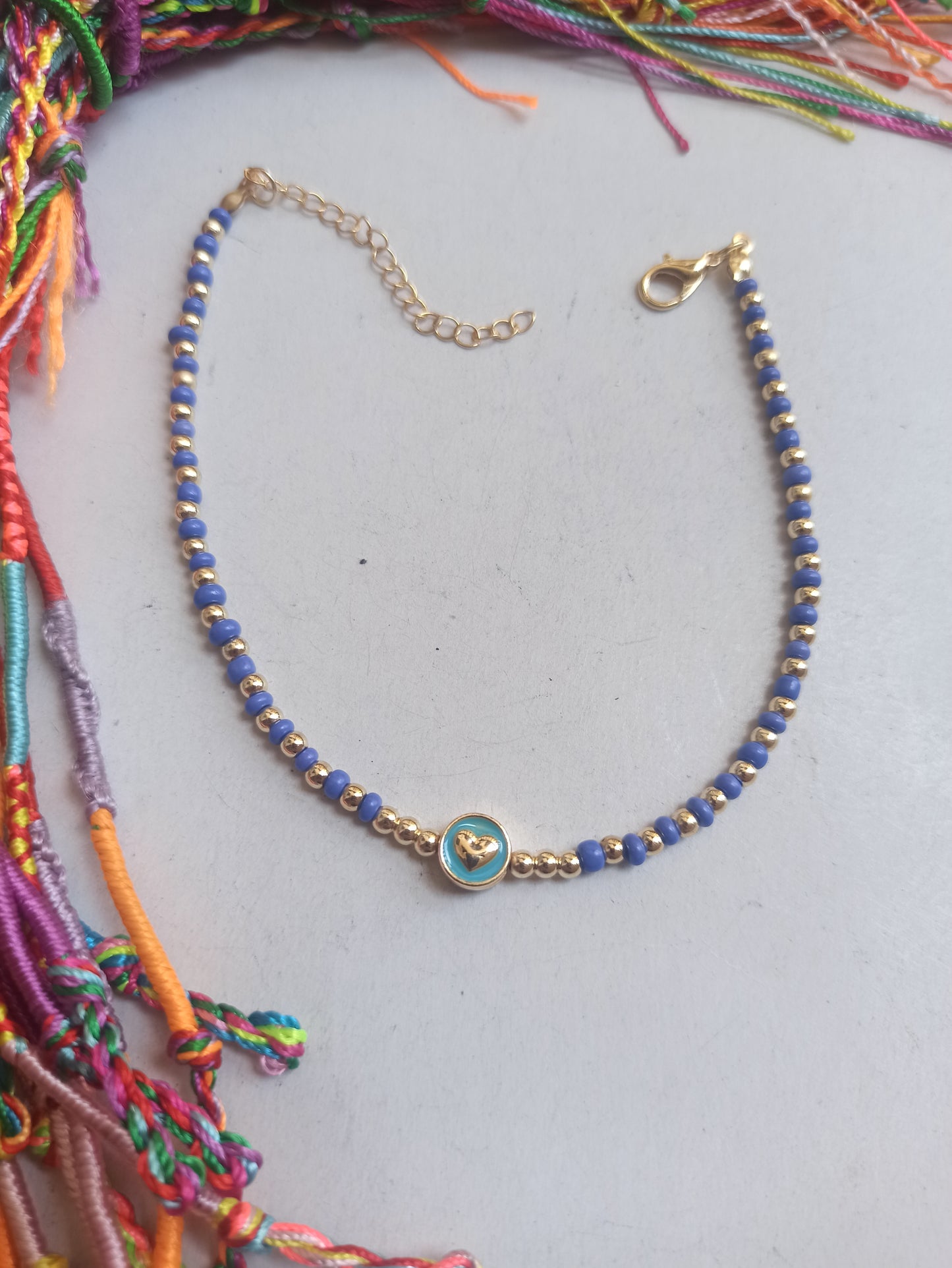 Golden anklet with little heart and blue beads