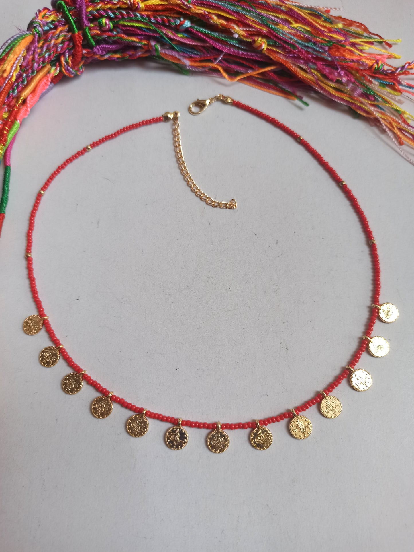 Thin beaded necklace with red coins