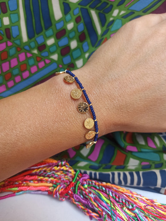 Thin beaded bracelet with blue coins