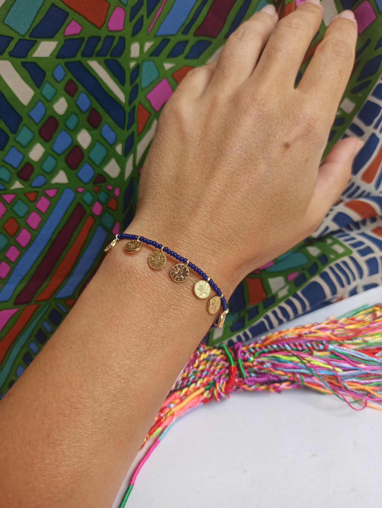 Thin beaded bracelet with blue coins