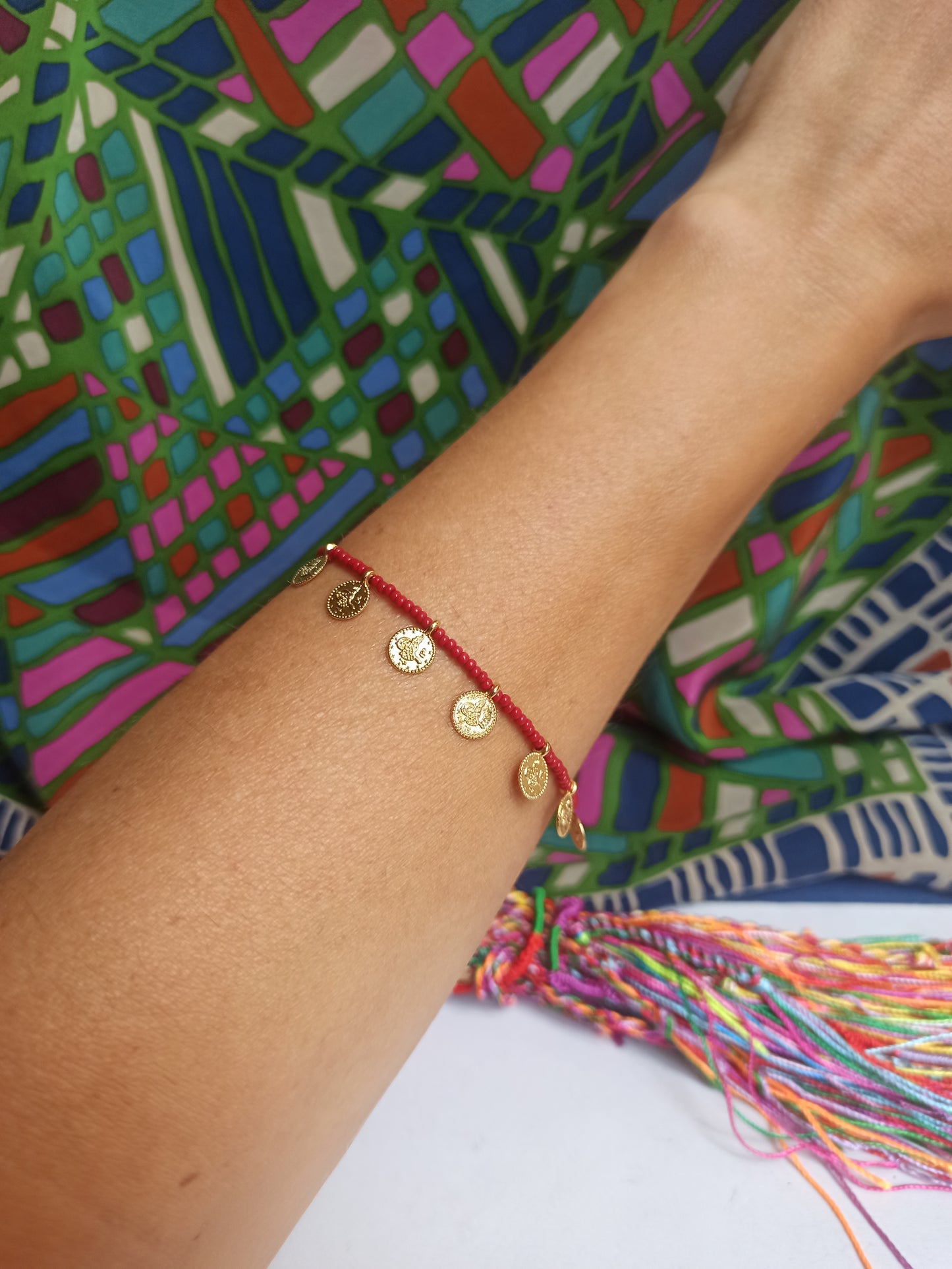 Thin bracelet with dark red coin beads