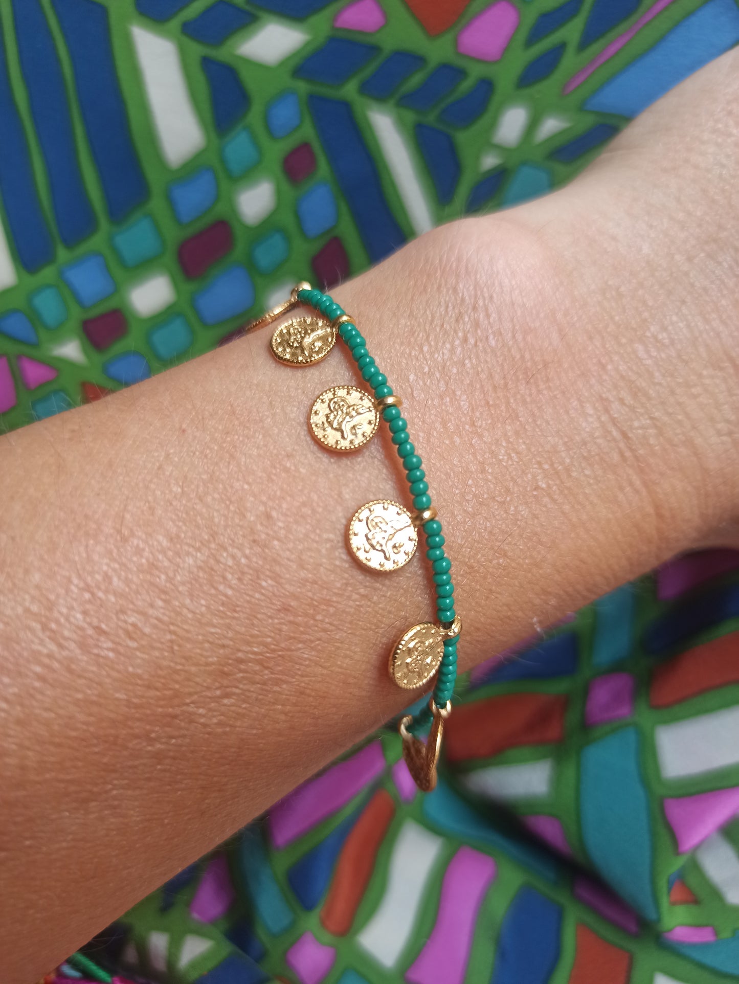 Thin beaded bracelet with green coins