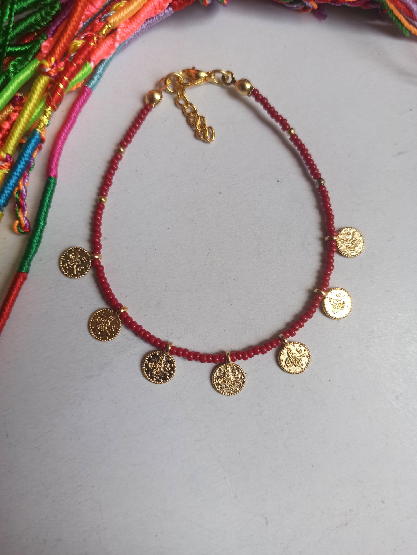 Thin bracelet with dark red coin beads