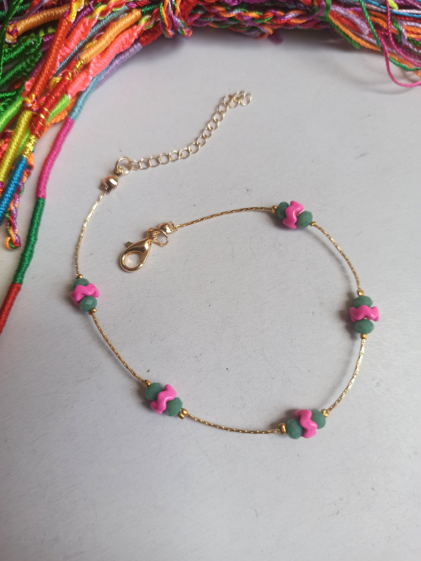 Golden anklet with fuchsia and turquoise decoration