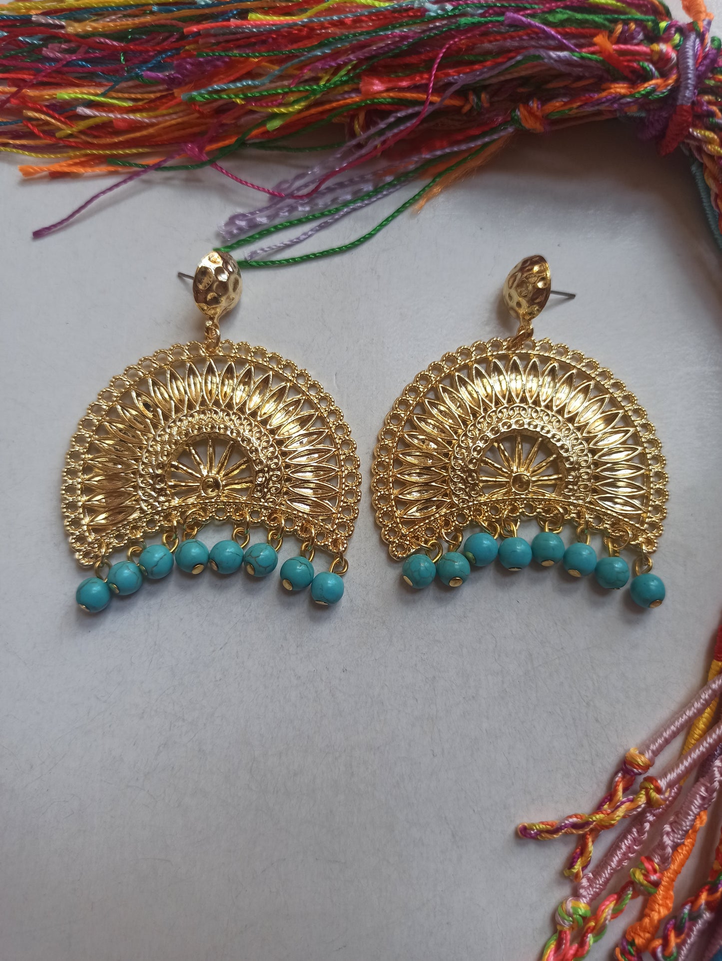 Golden bow earrings with turquoise beads