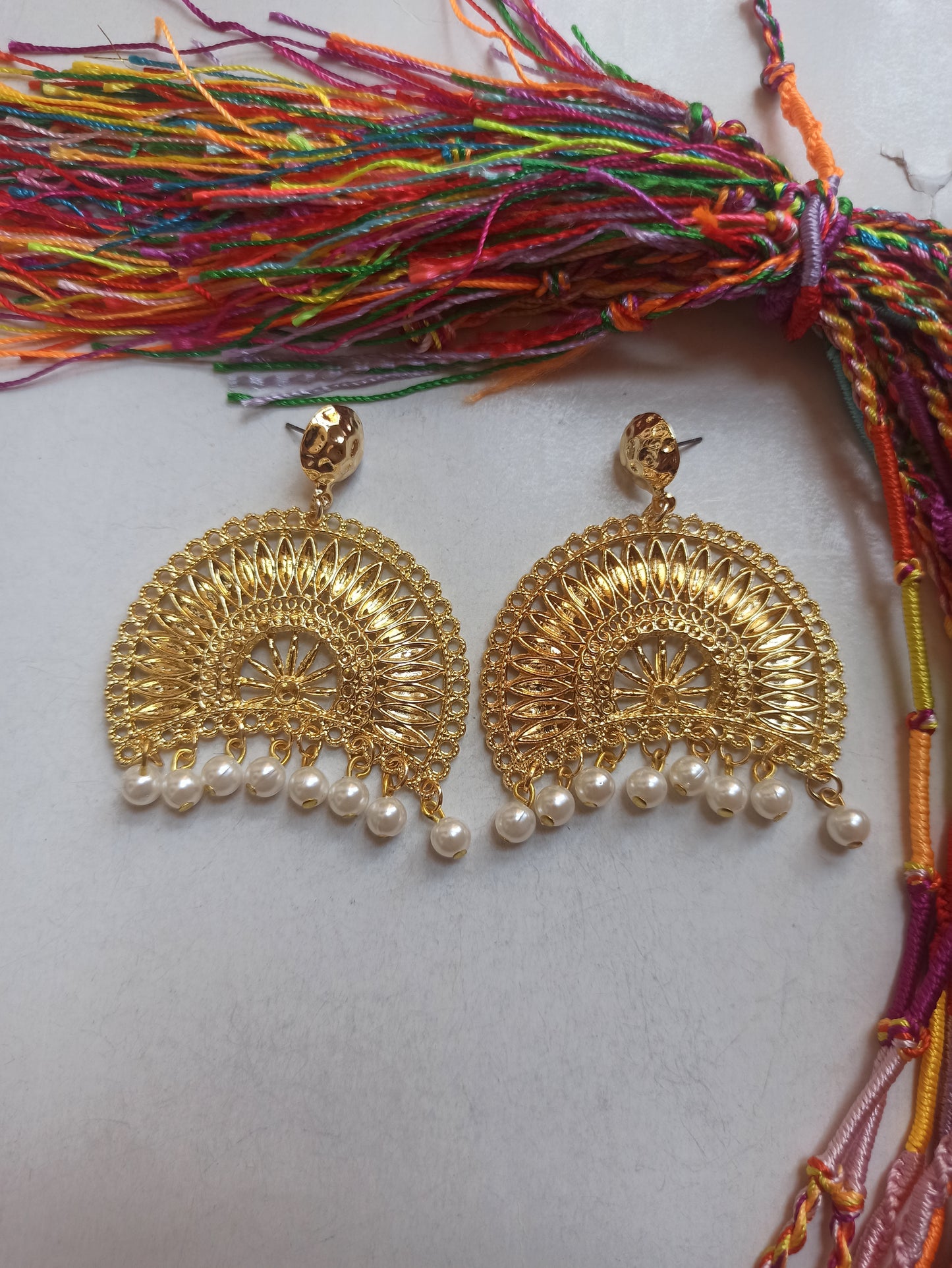 Golden bow earrings with white beads