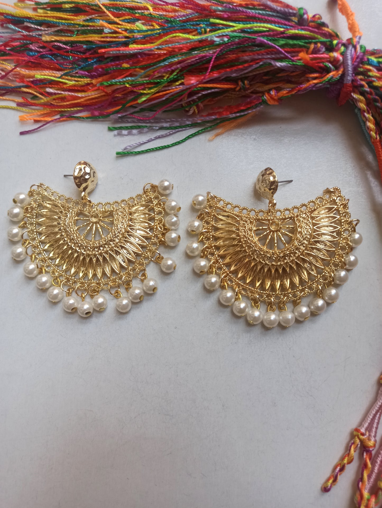 Golden bow earrings with white beads