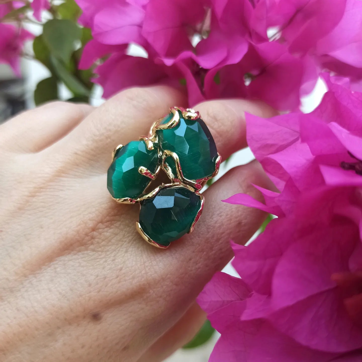 Golden ring with 3 bottle green stones