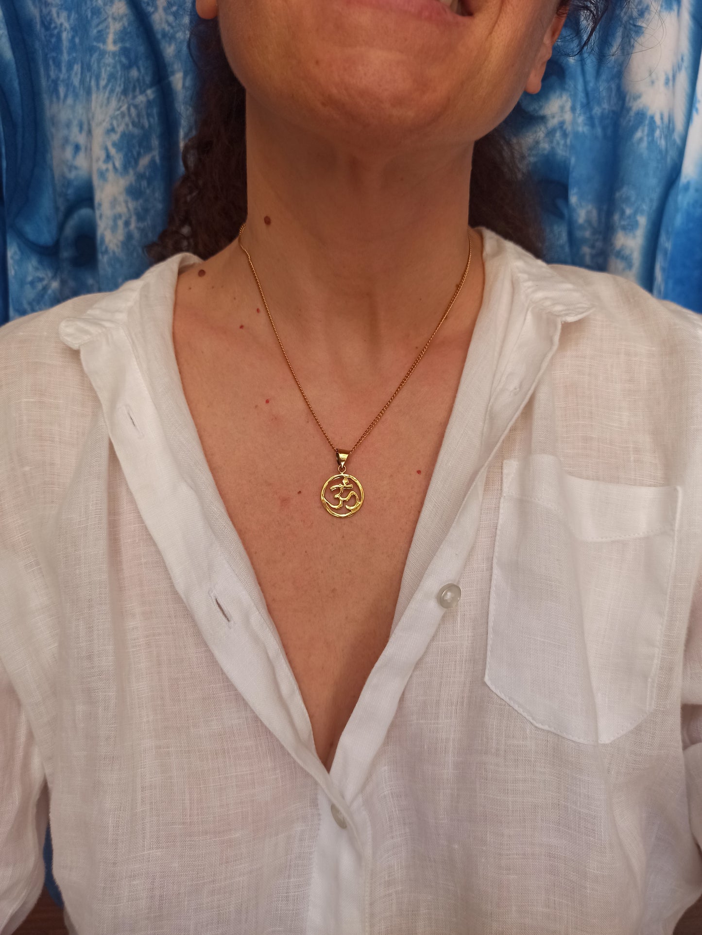 Golden necklace with ohm pendant