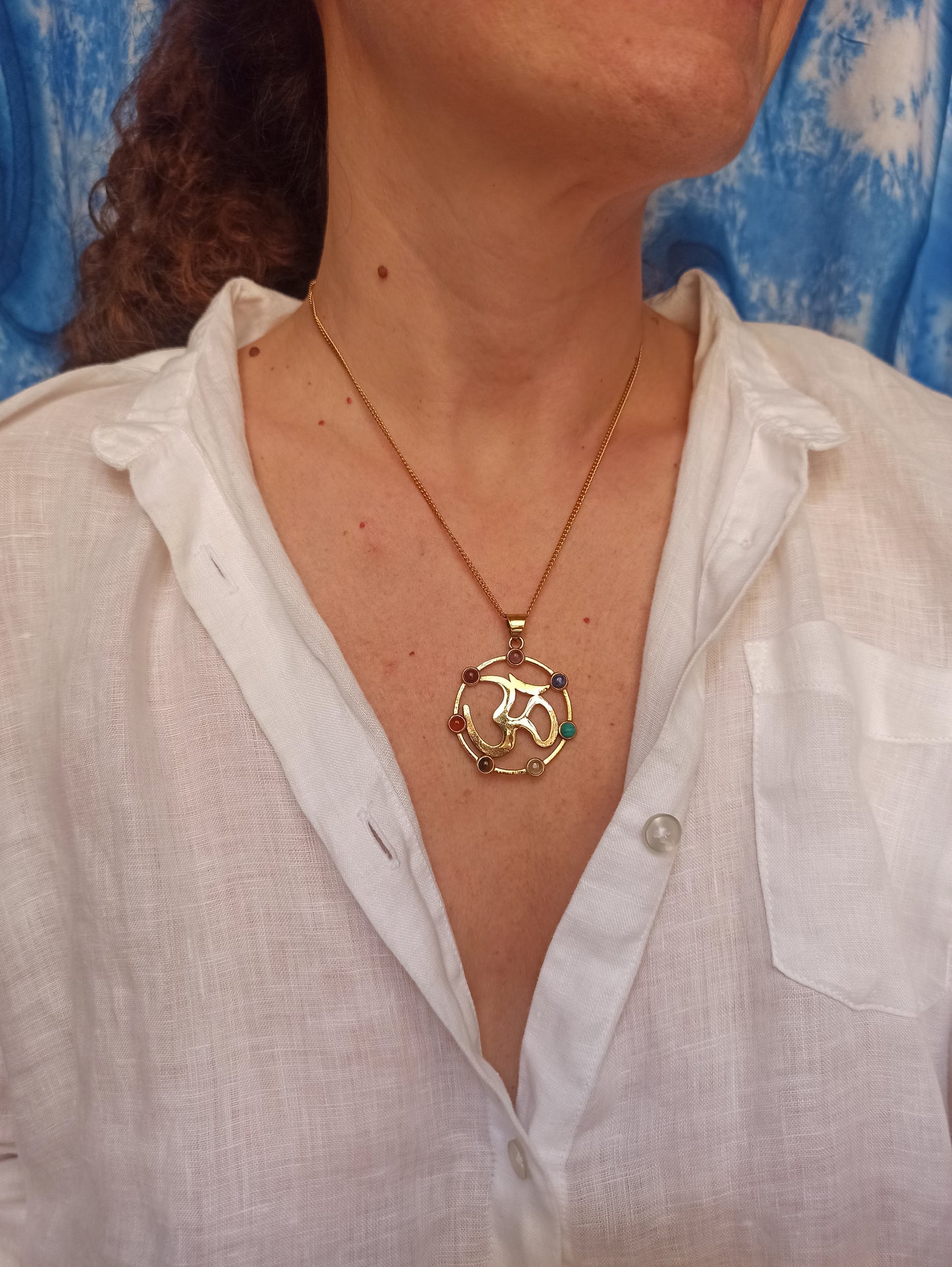 Golden necklace with seven chakra ohm pendant