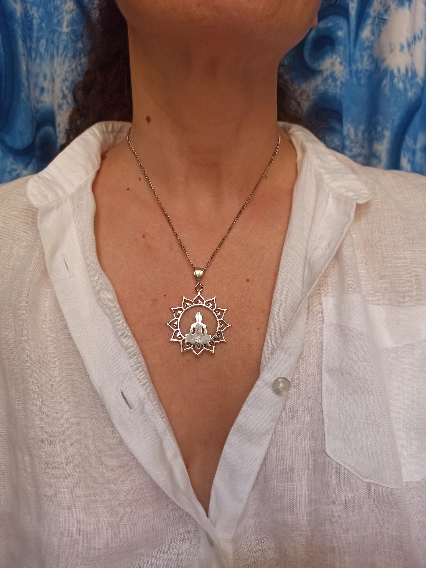 Silver necklace with buddha in the sun pendant