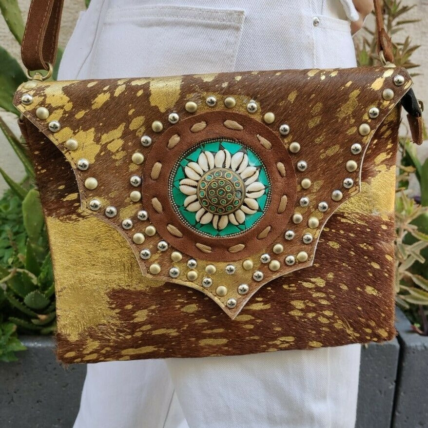 Golden leather shoulder bag with shell medallion