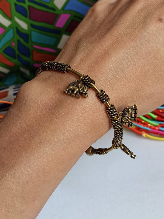 Thin golden bracelet with hanging elephants