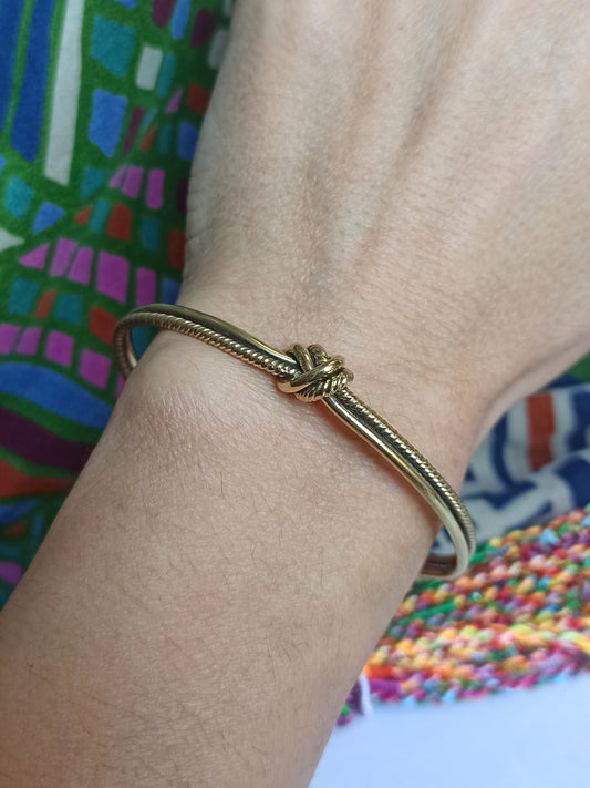 Thin golden knot bangle bracelet